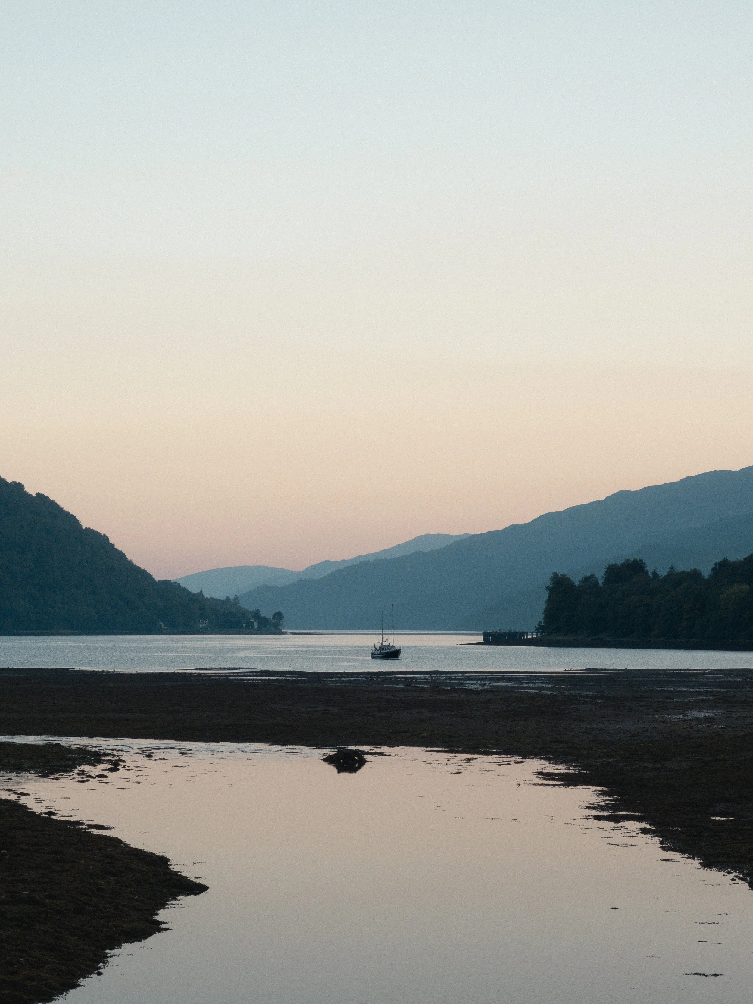 A sailboat stationary on Loch Long, near Arrochar.