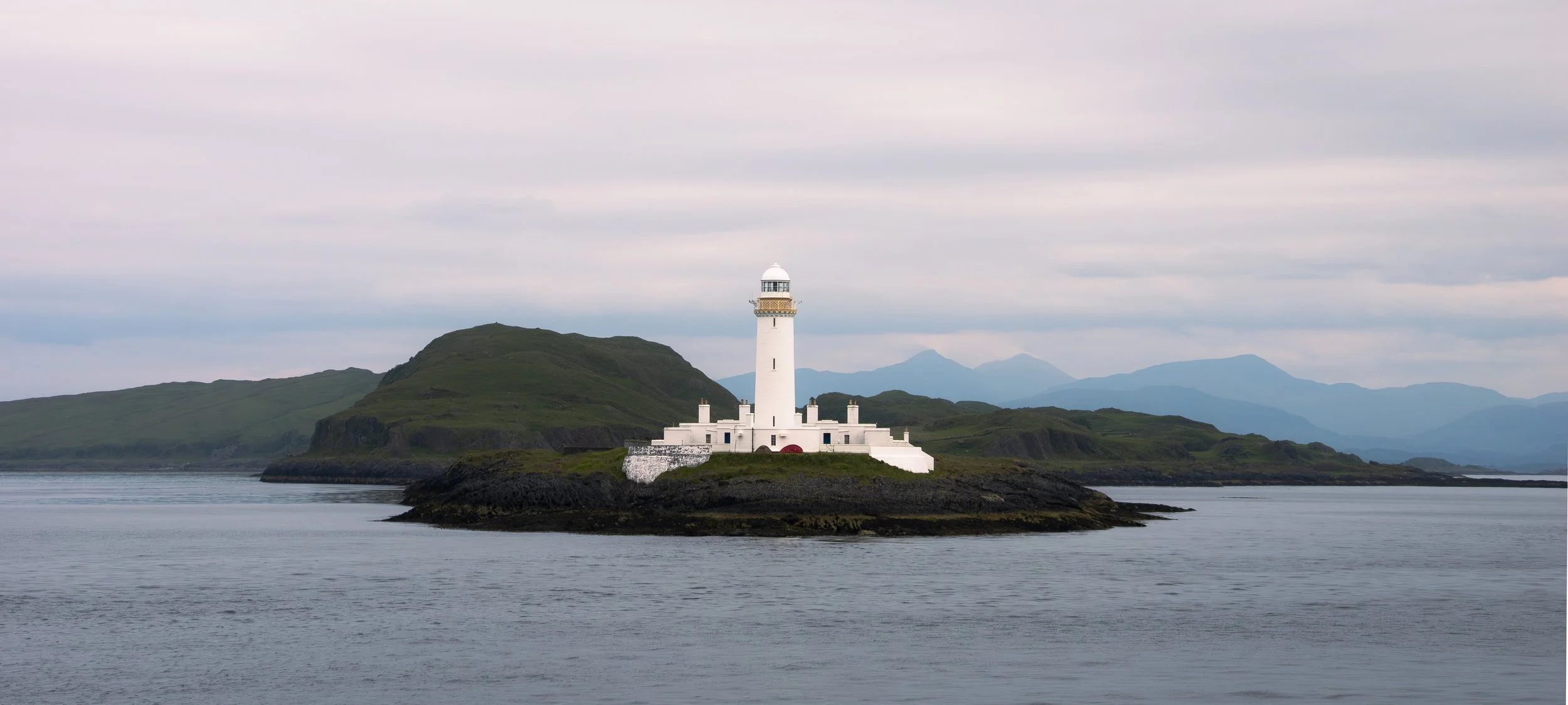 Lismore Lighthouse on a grey, cloudy day, taken onboard the Caledonian MacBrayne sailing from Mull.