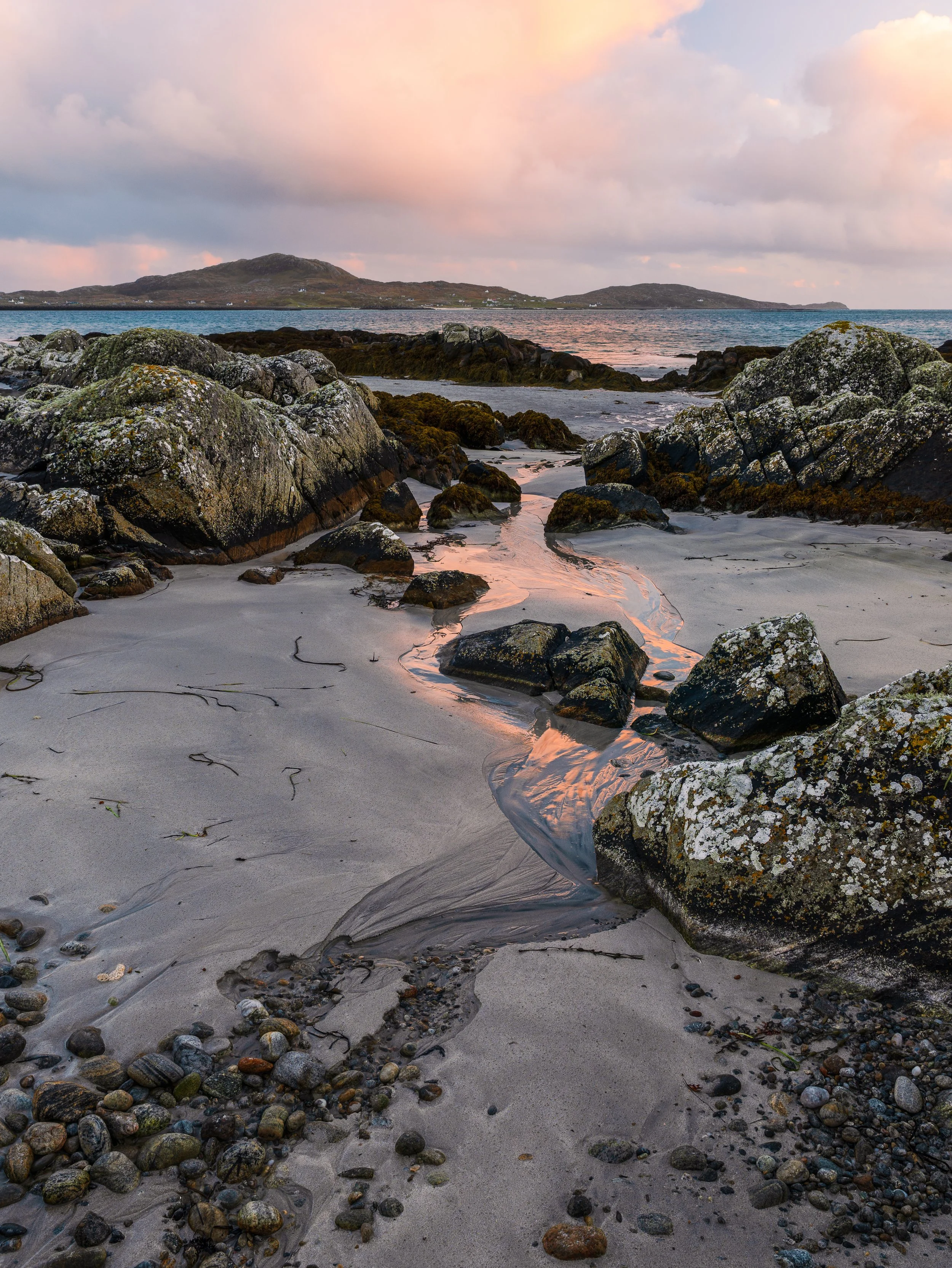 A small stream on a beach on South Uist leading out to the Isle of Eriskay.