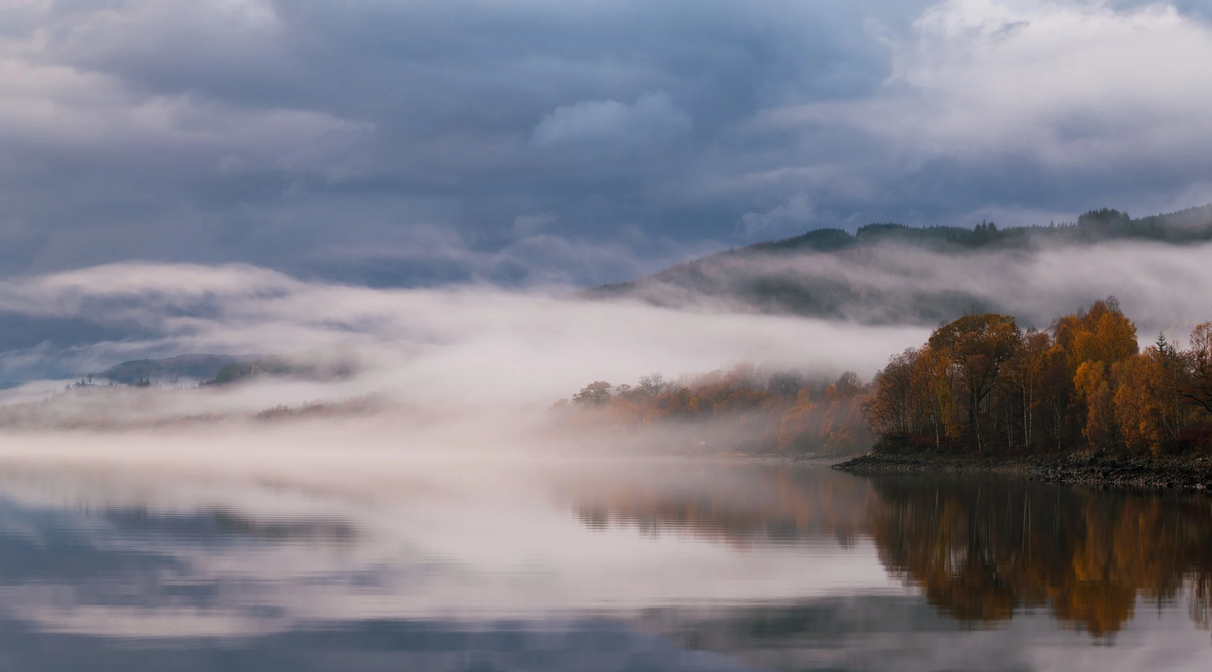 Mist hanging over an autumnal Loch Garry.