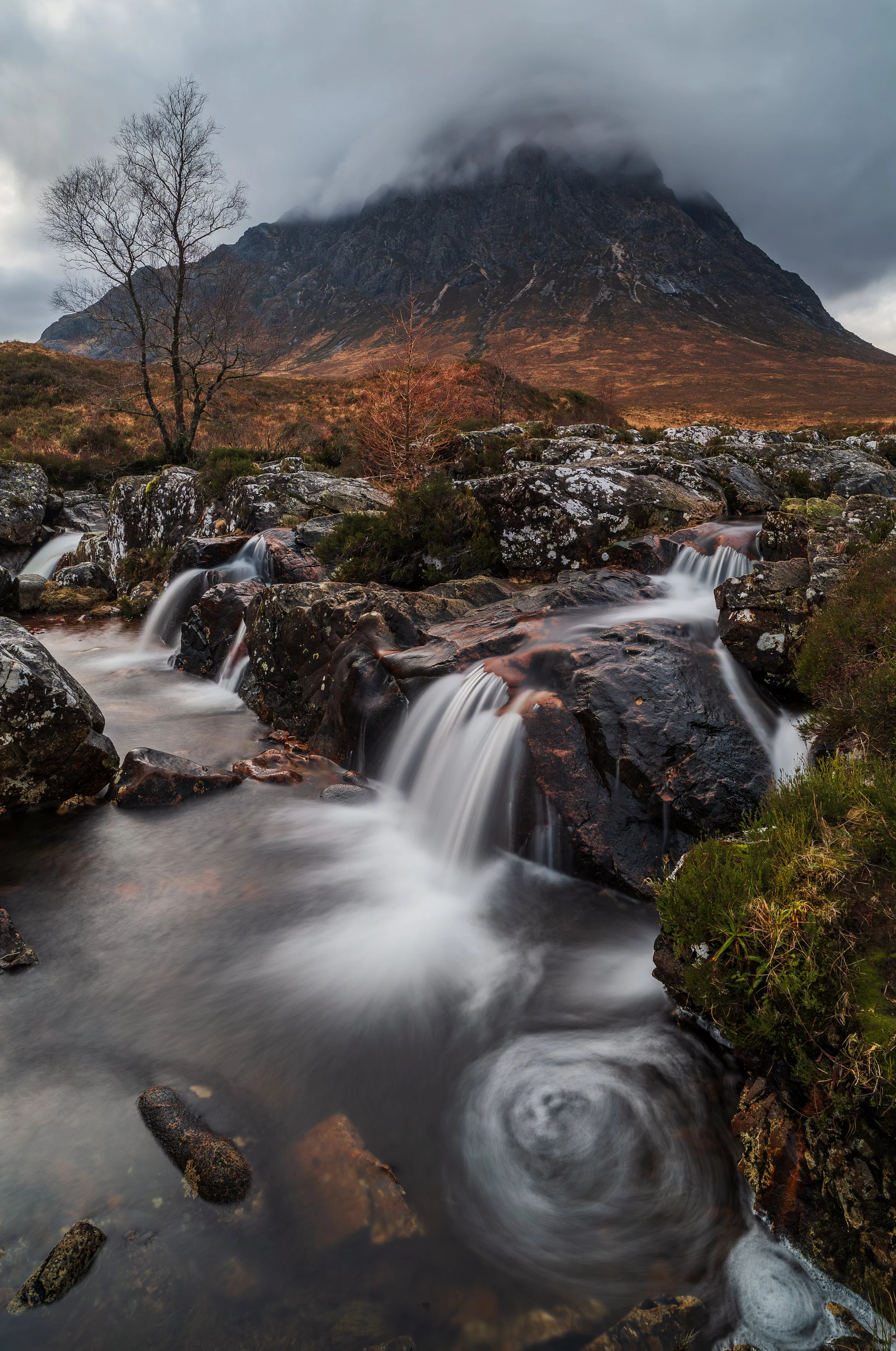 A waterfall on the River Coupall with the Buachaille Etive Mòr in the background.