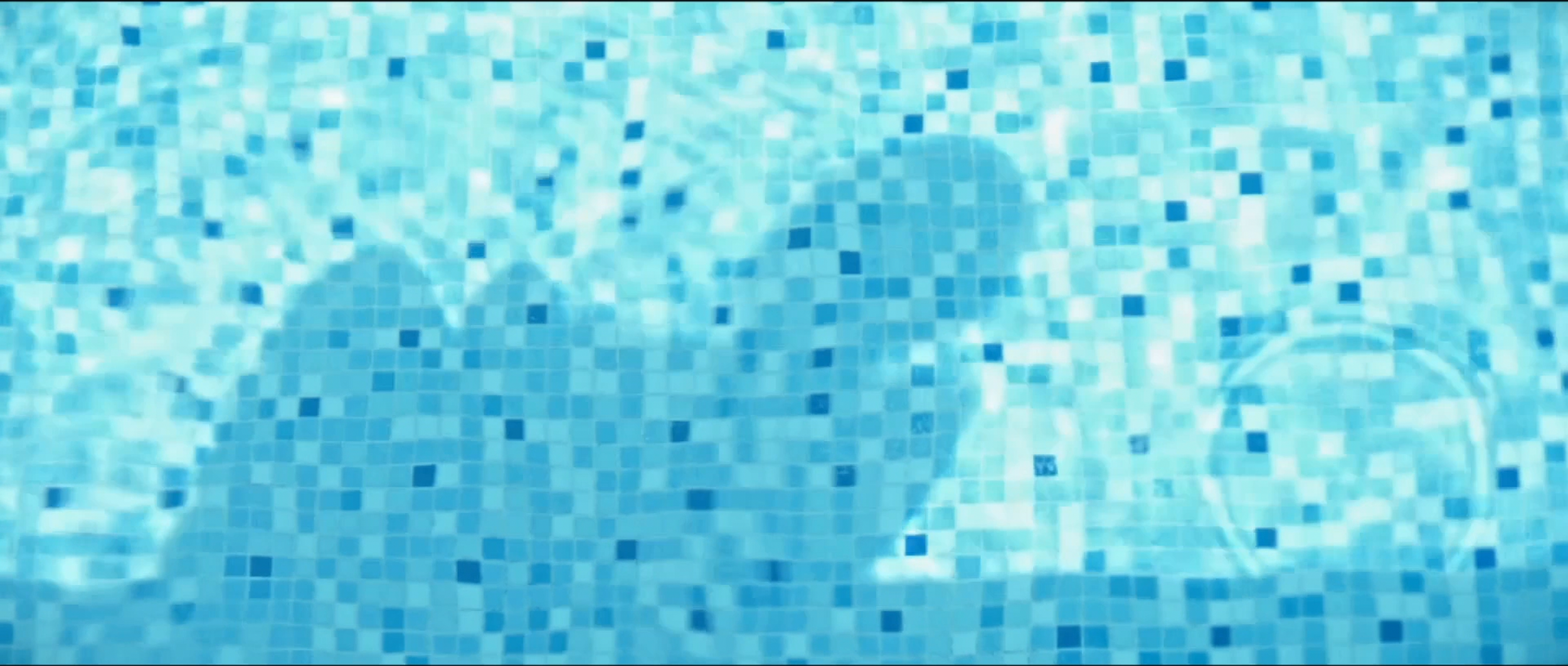 Close-up of a swimming pool with a mosaic tiled floor.