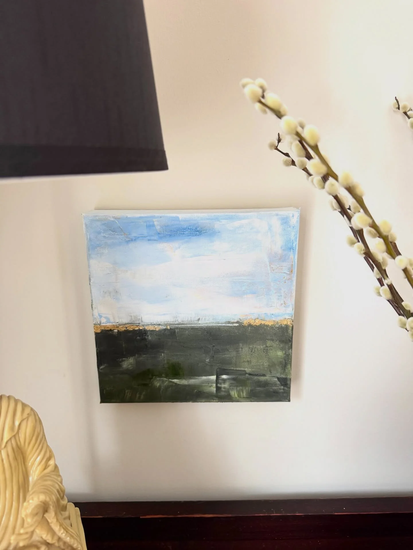 A favorite little spot. And an example of how a small painting can work in an unusual spot. 

I found this beautiful piece of furniture years ago for $10 on marketplace 😱 and the vase/holder in Uruguay at a flea market. Added willow for a funky touc