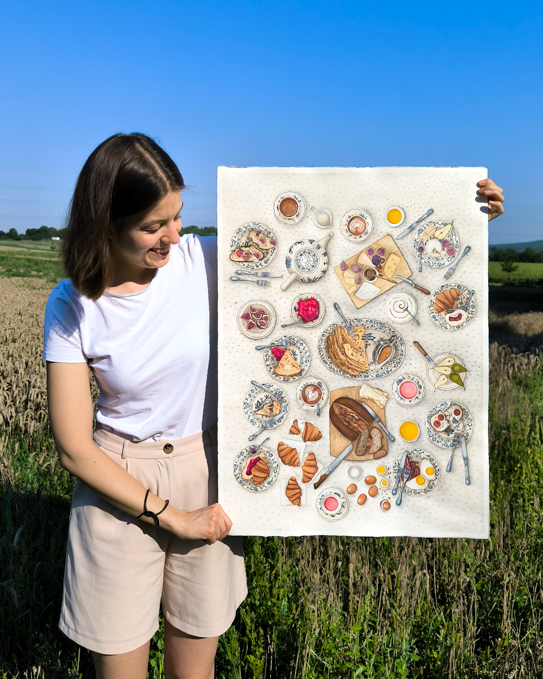 Woman holding a large food illustration, watercolor artist, learn more about her her, portfolio