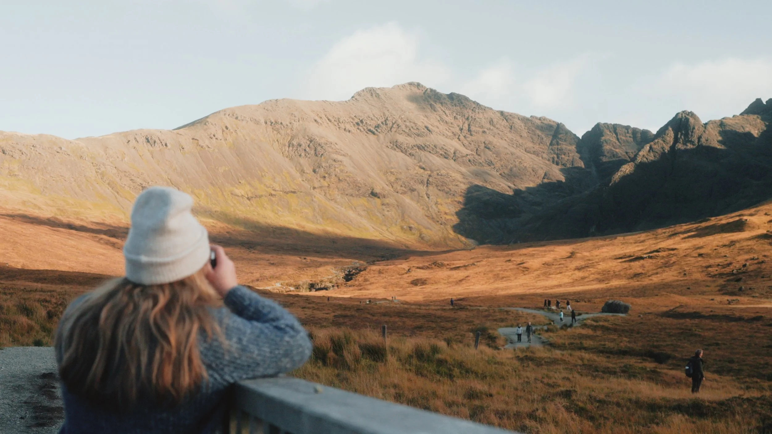  In this first shot, the protagonist is placed on the lower half of the frame, making her seem smaller compared to the vast landscape of mountains ahead of her. 