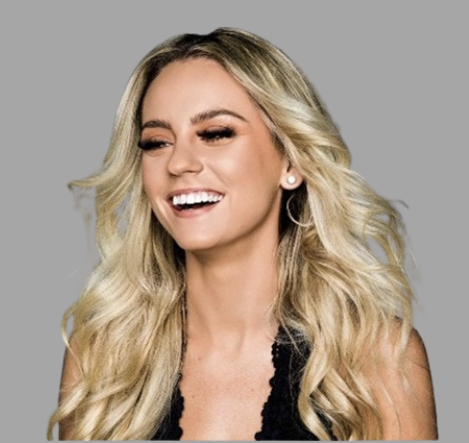 Blonde woman with wavy hair smiling and winking, wearing a black top, against a gray background.