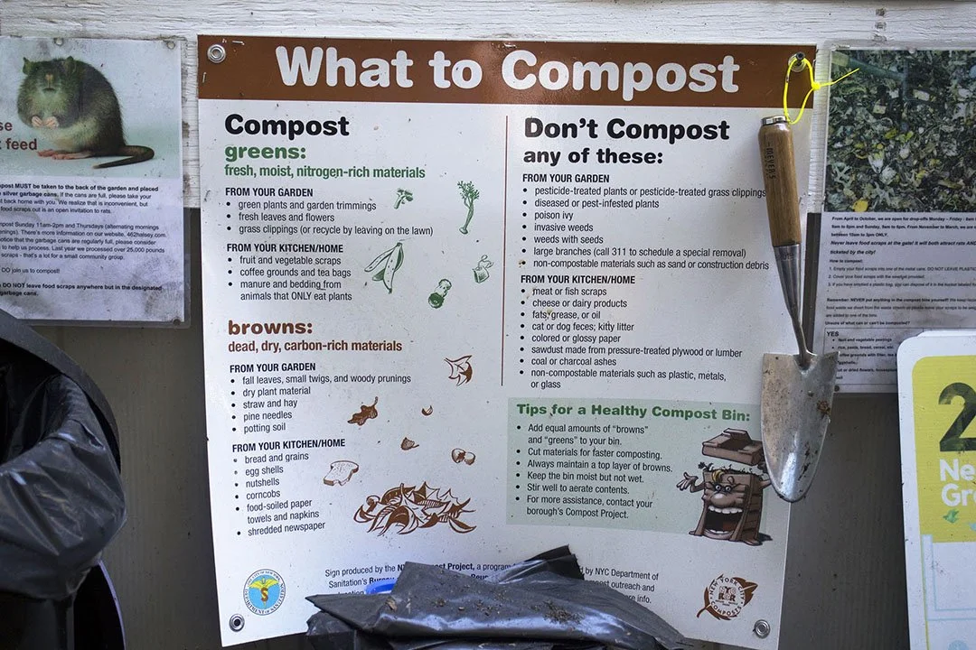 Poster titled 'What to Compost' with sections listing compostable greens and browns, items not to compost, tips for a healthy compost bin, and a small gardening trowel attached to the top right corner.