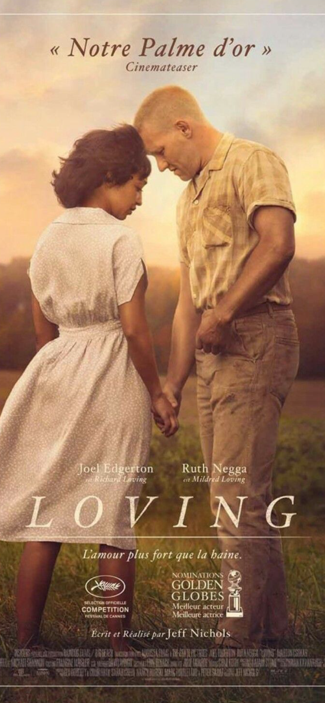 Movie poster for 'Loving' featuring a young Black girl and a White man holding hands, with their foreheads touching, in a field at sunset.