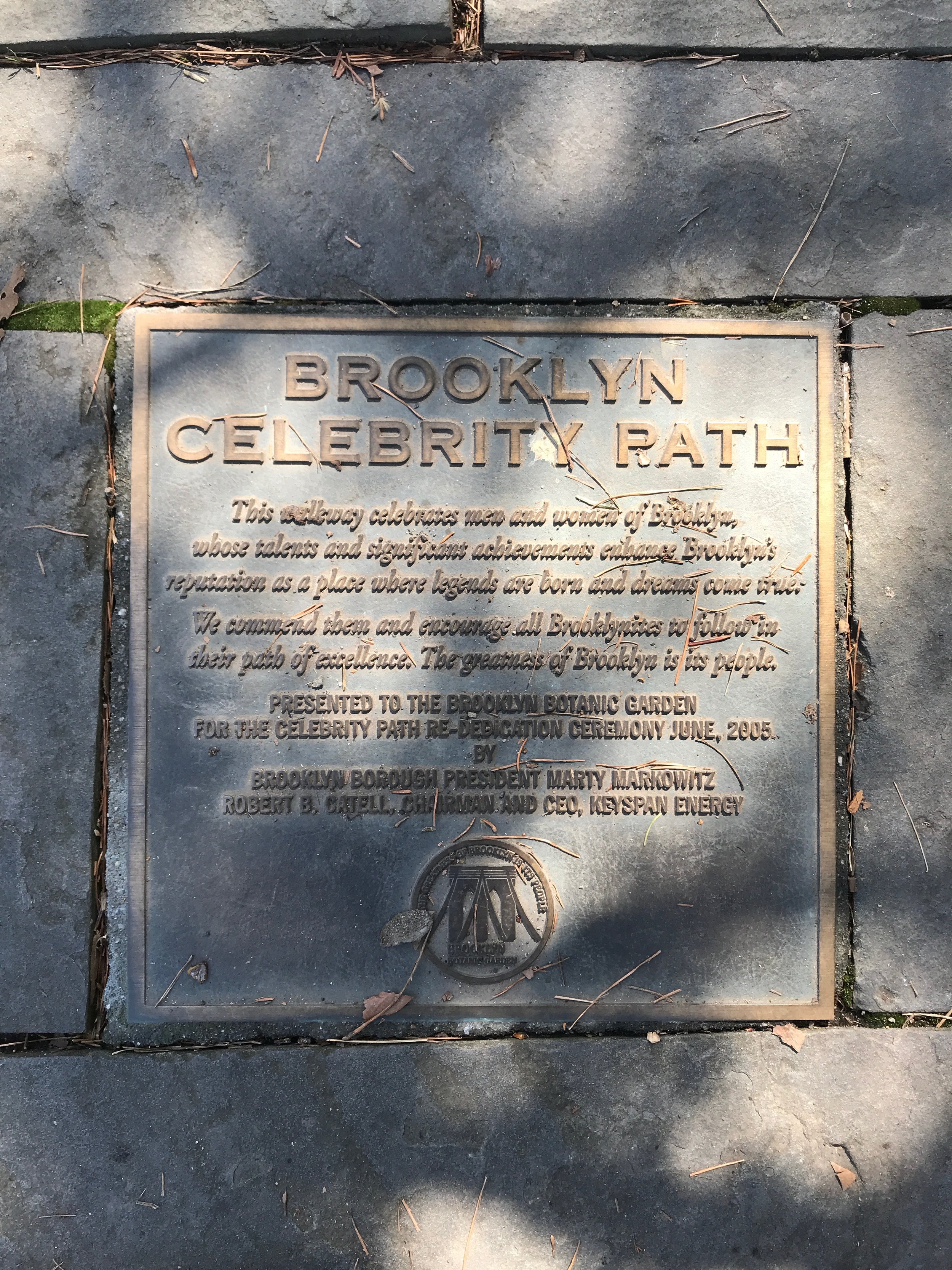 A metal plaque on the sidewalk commemorates the Brooklyn Celebrity Path, dedicated in June 2005 by Brooklyn President Marty Markowitz and CEO of KeySpan Energy.