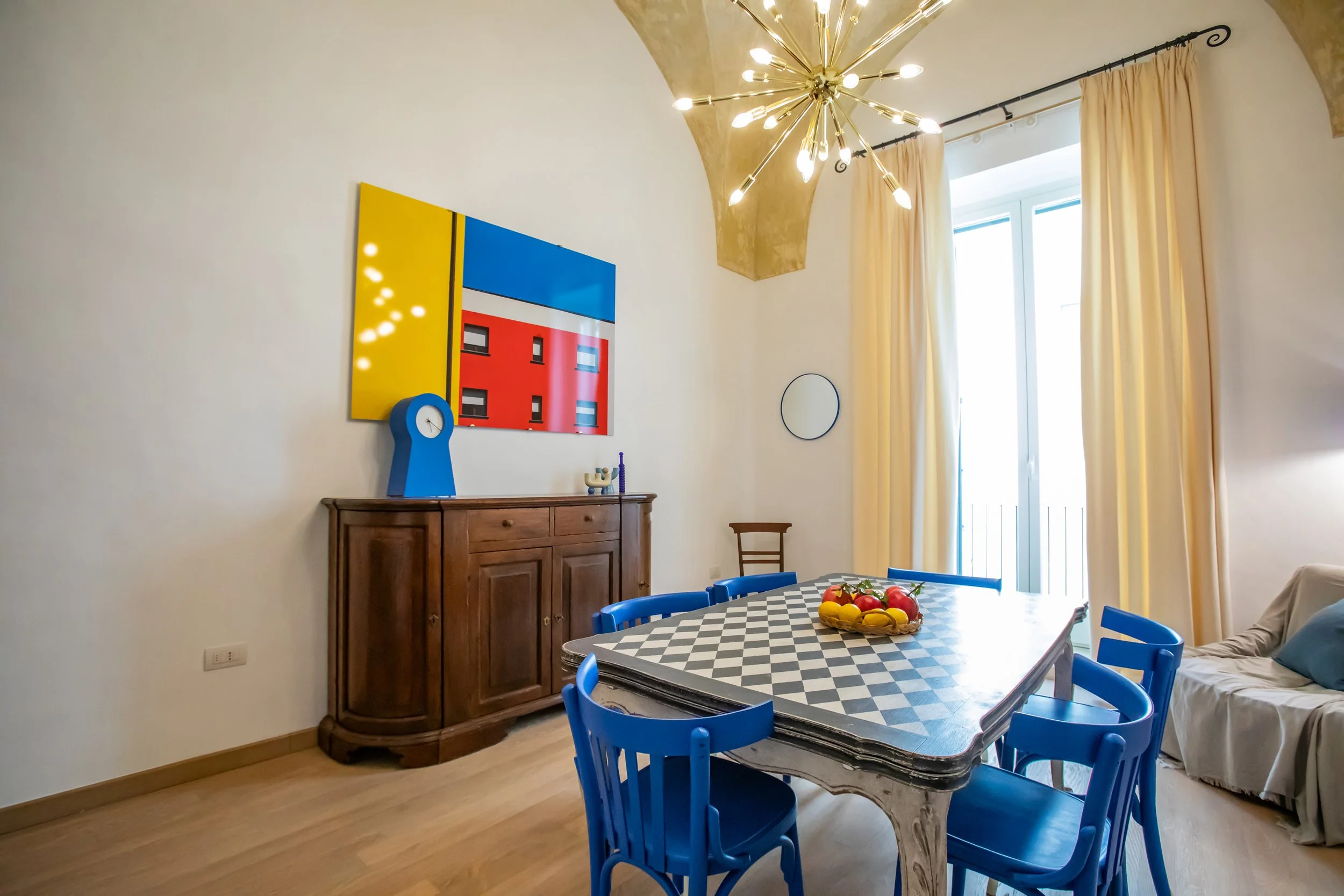 Bright and carefully curated dining room at Palazzo Dolce Vita, with colourful details, natural light and a welcoming atmosphere.