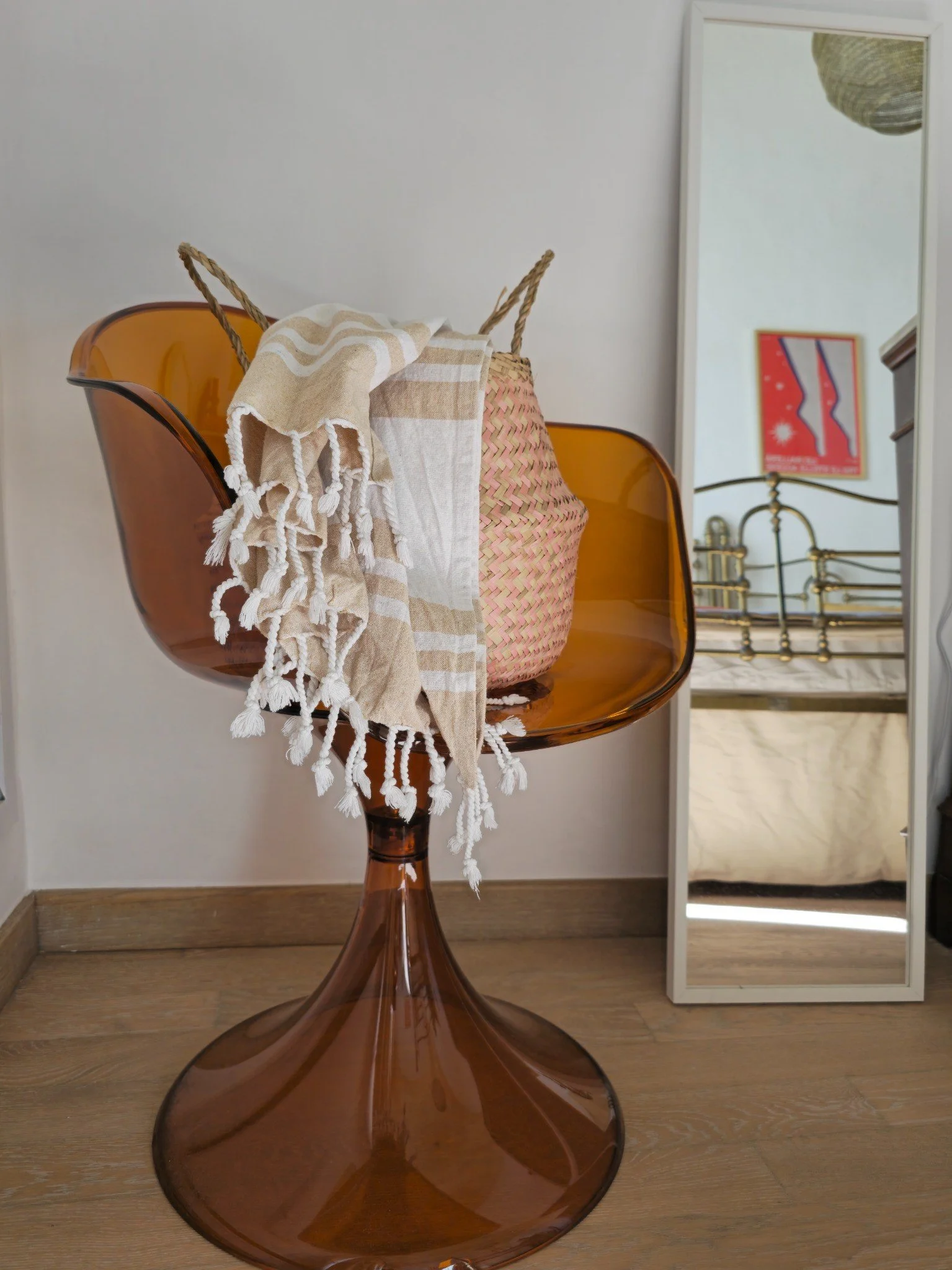 Design chair in the master bedroom at Palazzo Dolce Vita, with soft textiles and a mirror reflecting the room’s atmosphere.