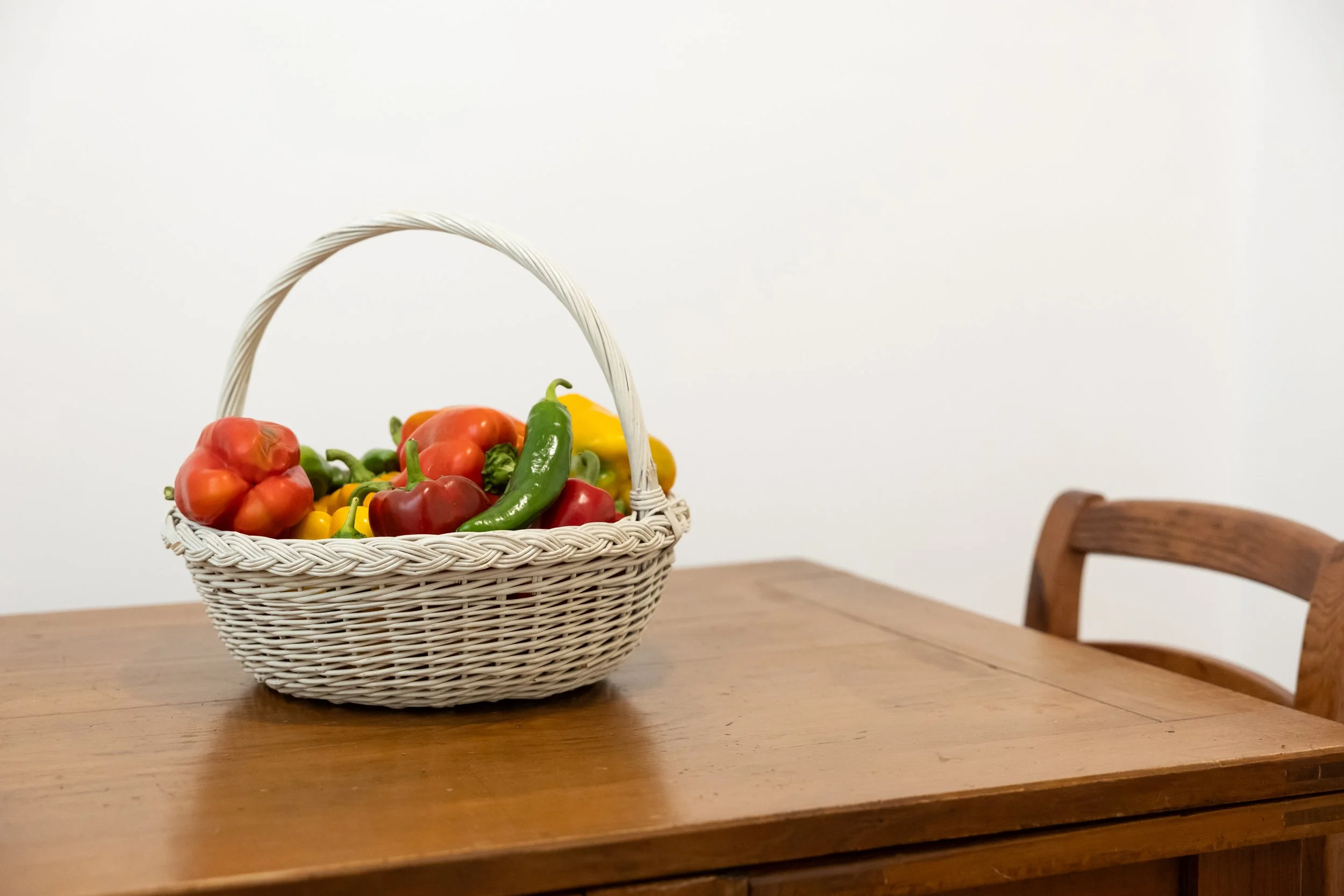 Fresh peppers on the wooden table in the kitchen coffee corner at Palazzo Dolce Vita.