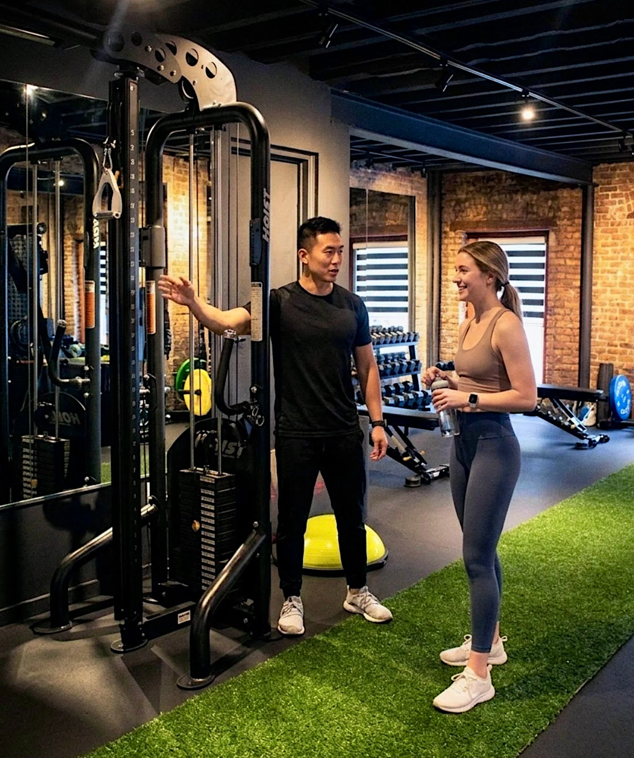 Trainer and Client by cable machine.jpg