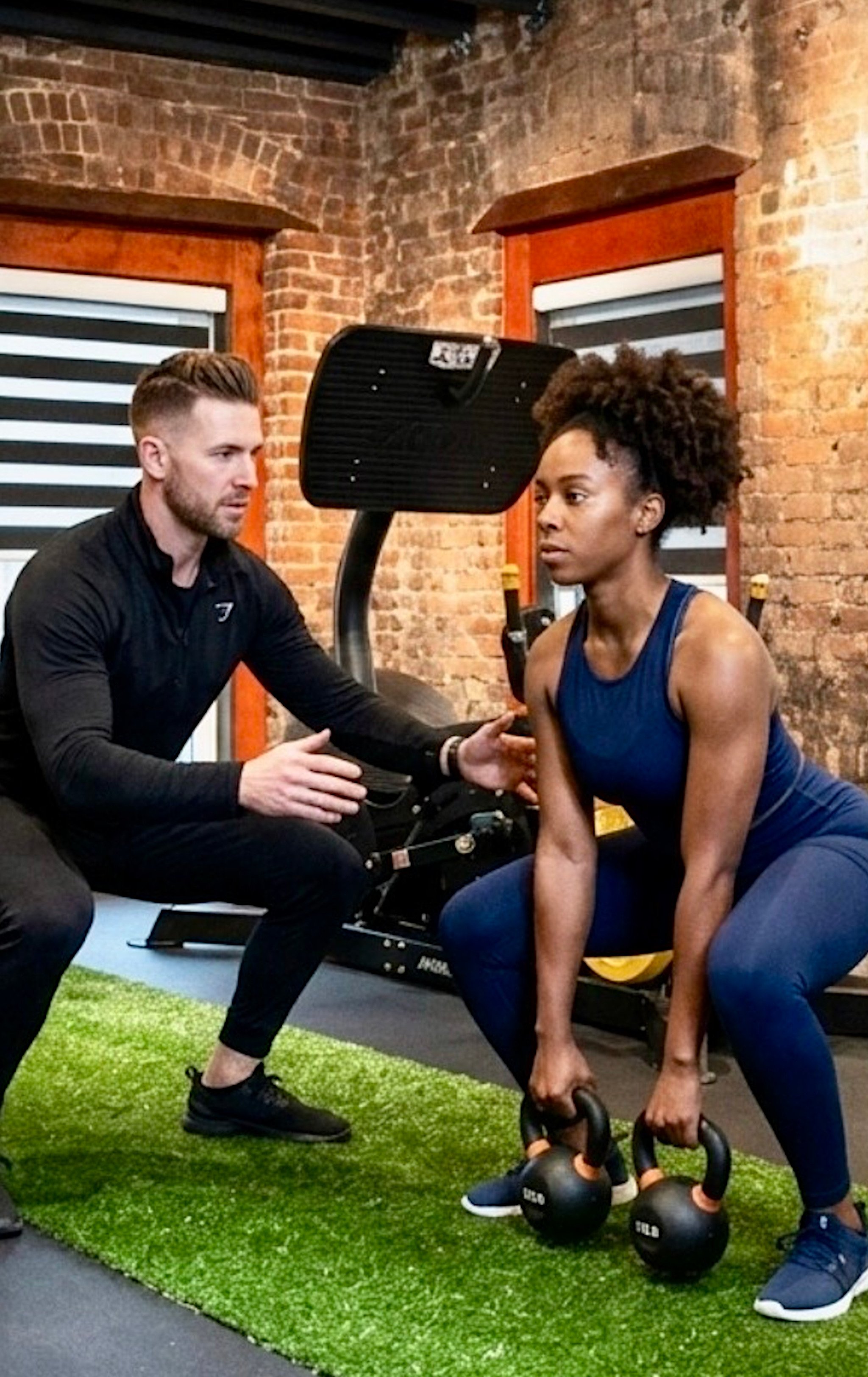 Client with trainer and kettle bells.jpg