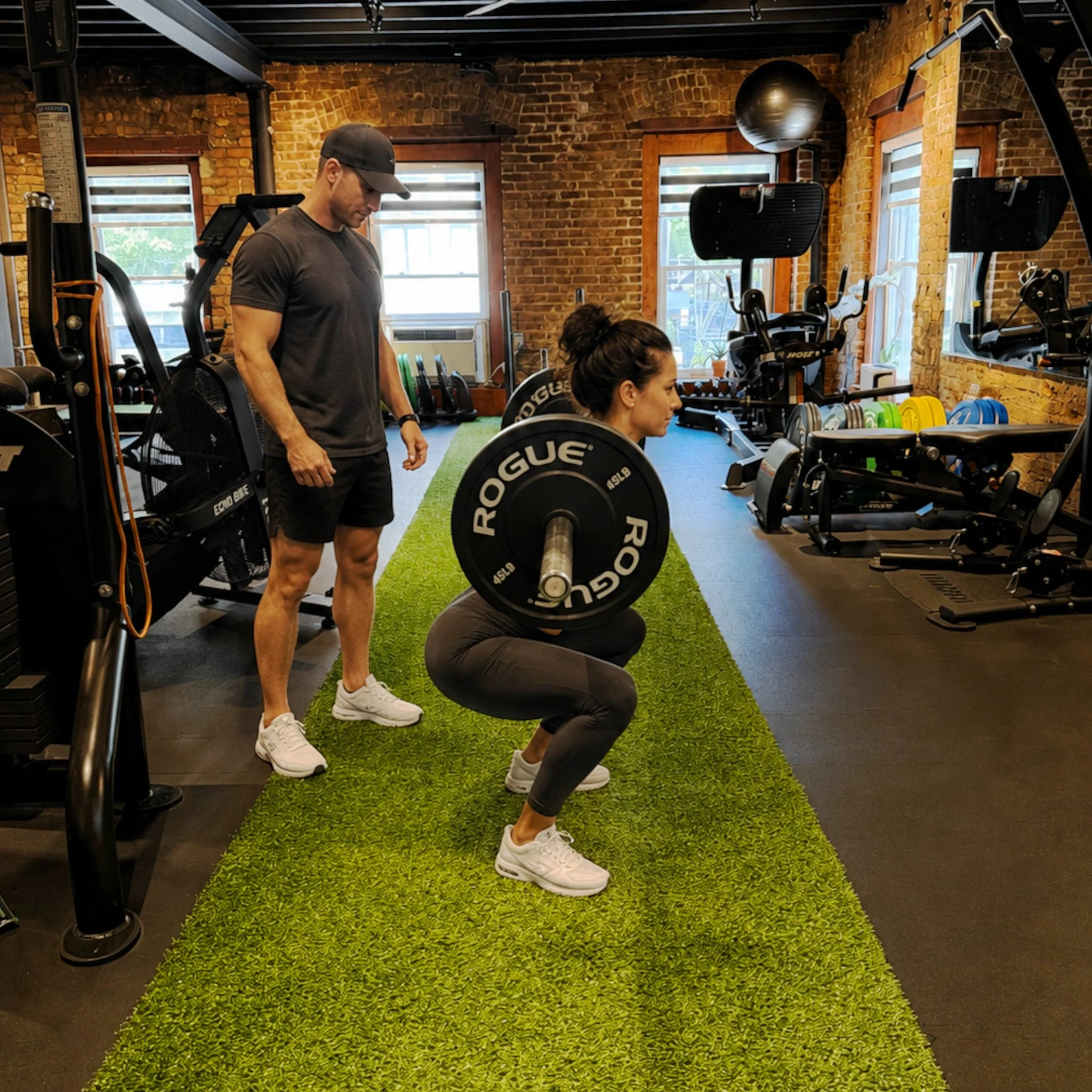 Client doing squats with trainer.jpg