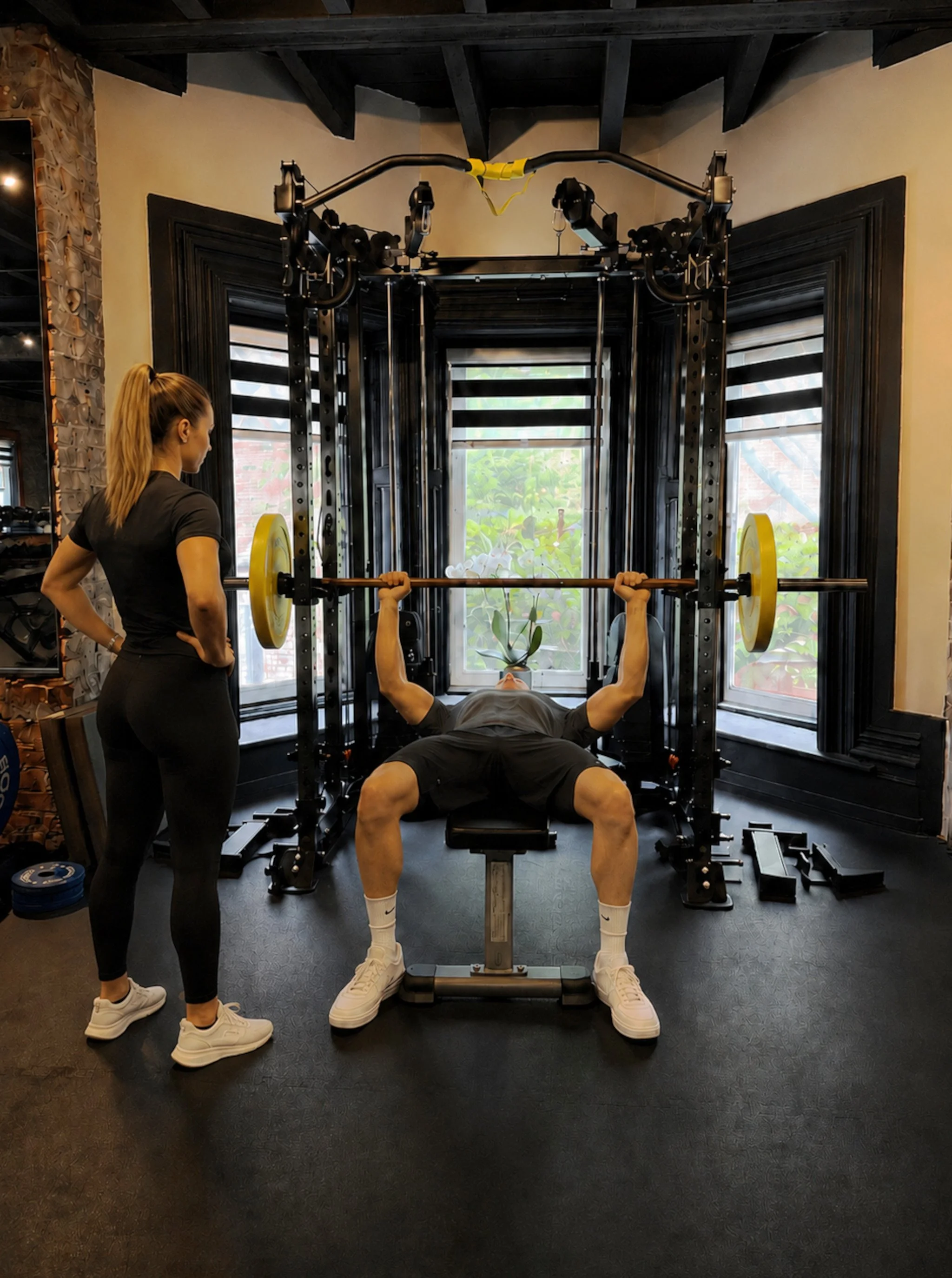 Client doing benchpress with Trainer.jpg