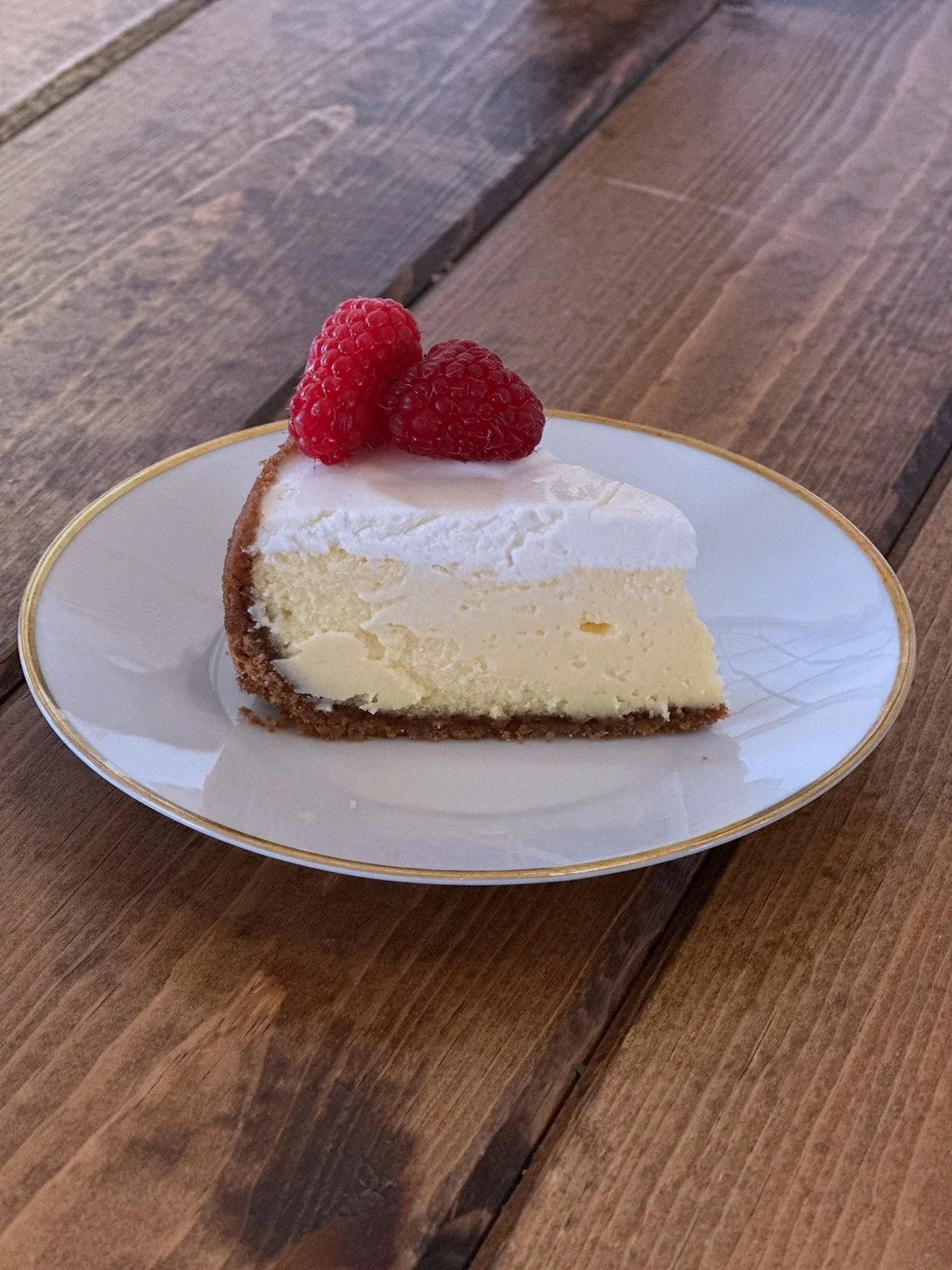 Slice of cheesecake with raspberries