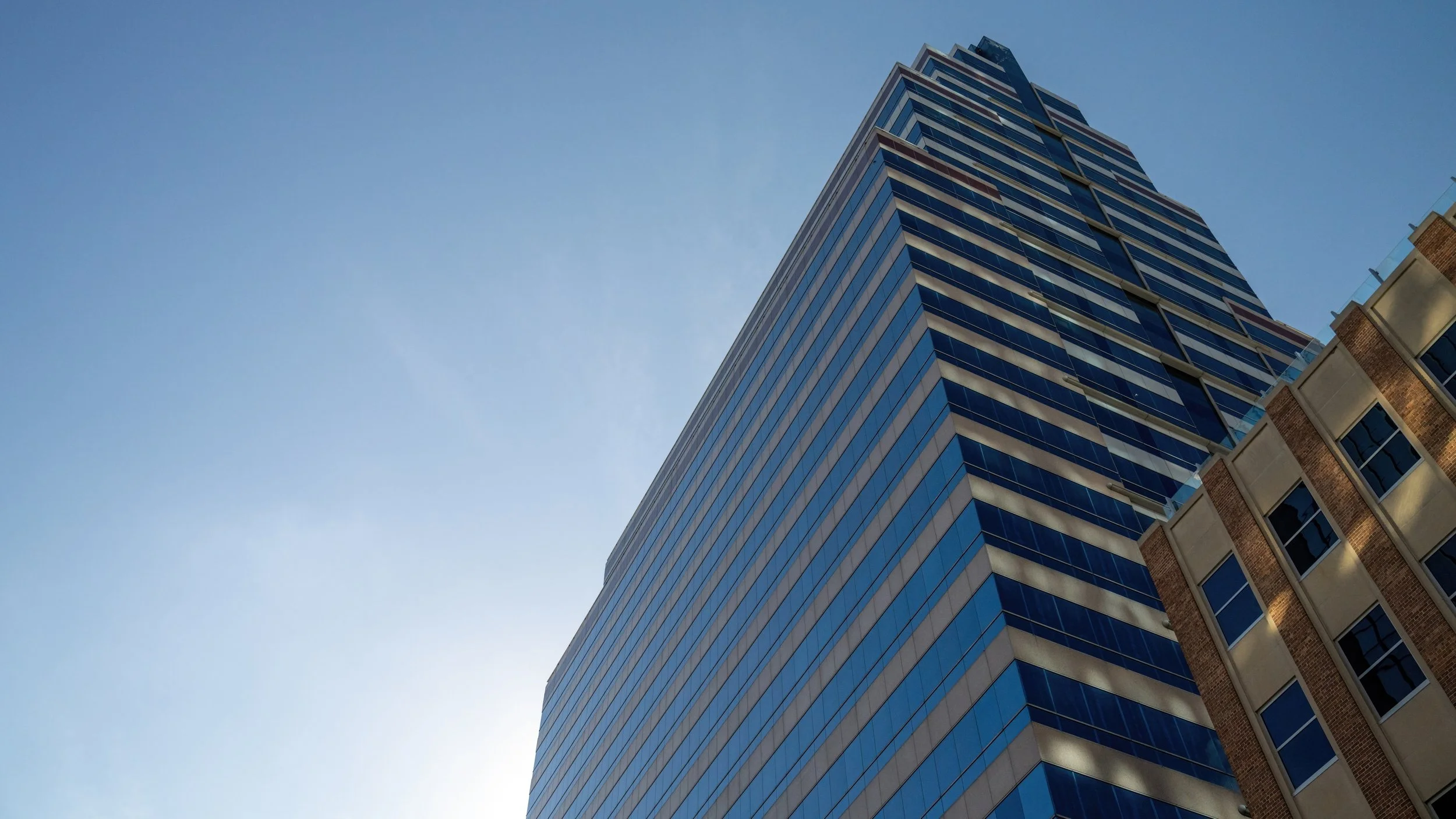 Modern glass commercial high-rise suitable for office, retail, or mixed-use in downtown Jacksonville, an urban Florida market.