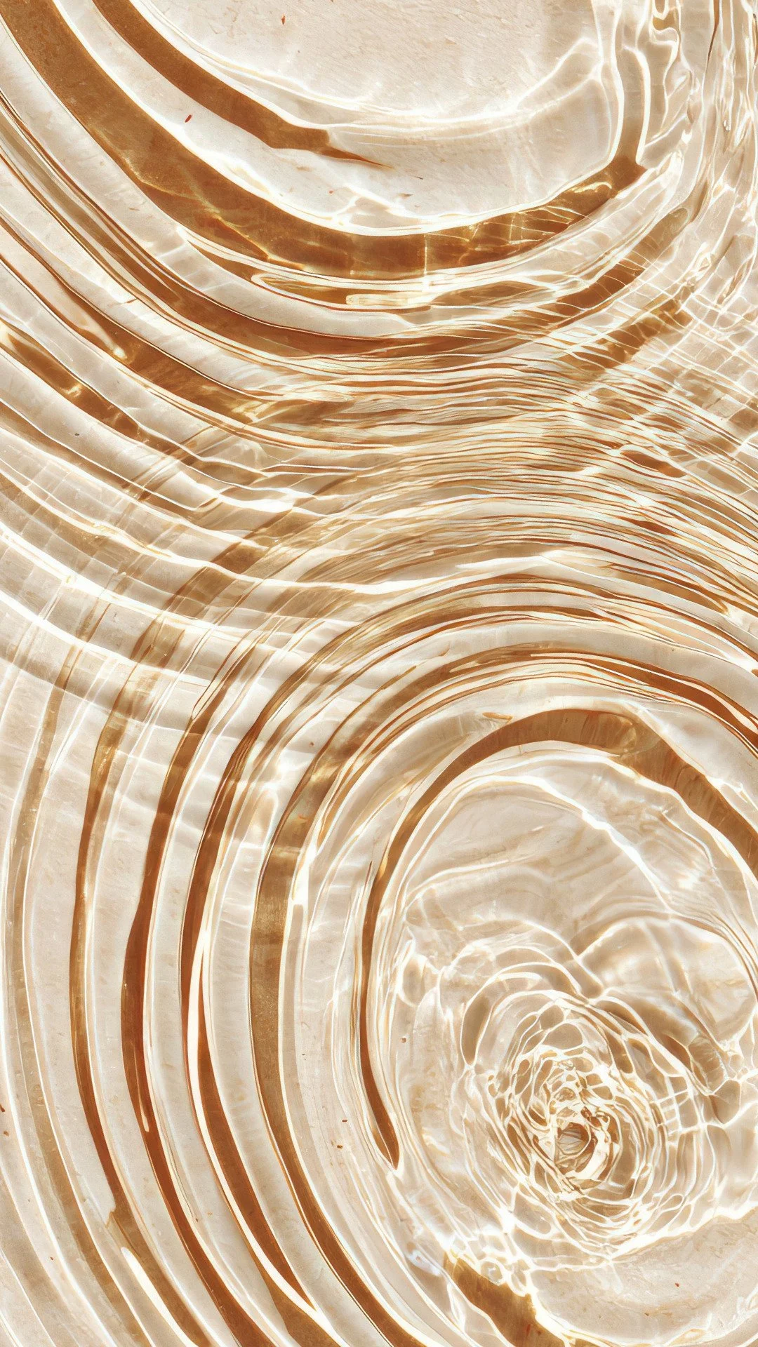 Close-up of swirling water and light reflections creating concentric circles.