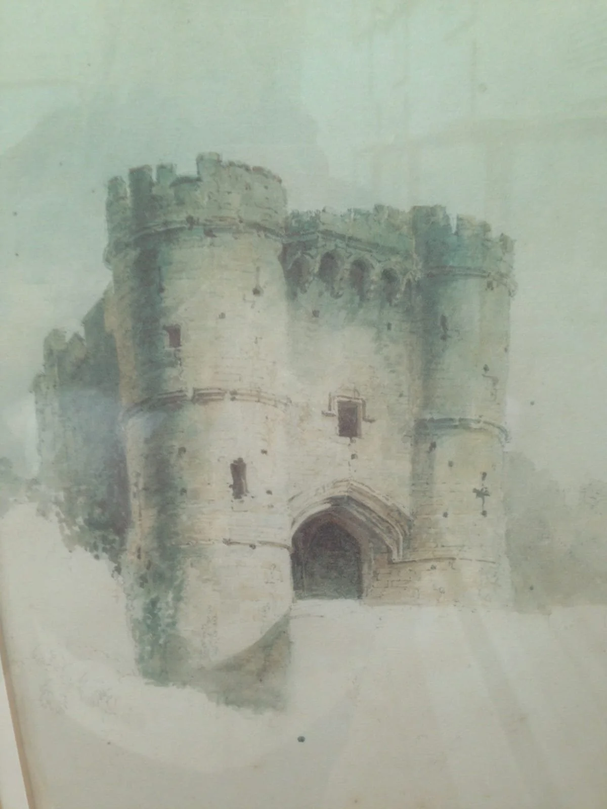 Watercolor painting of a medieval castle with round towers and an arched entrance.
