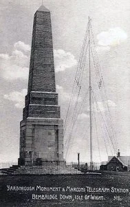 A historical black and white photograph of the Yarbrough Monument and Marconi Telegraph Station in Bemde, showing a tall obelisk and a communication mast with a small building at the base.