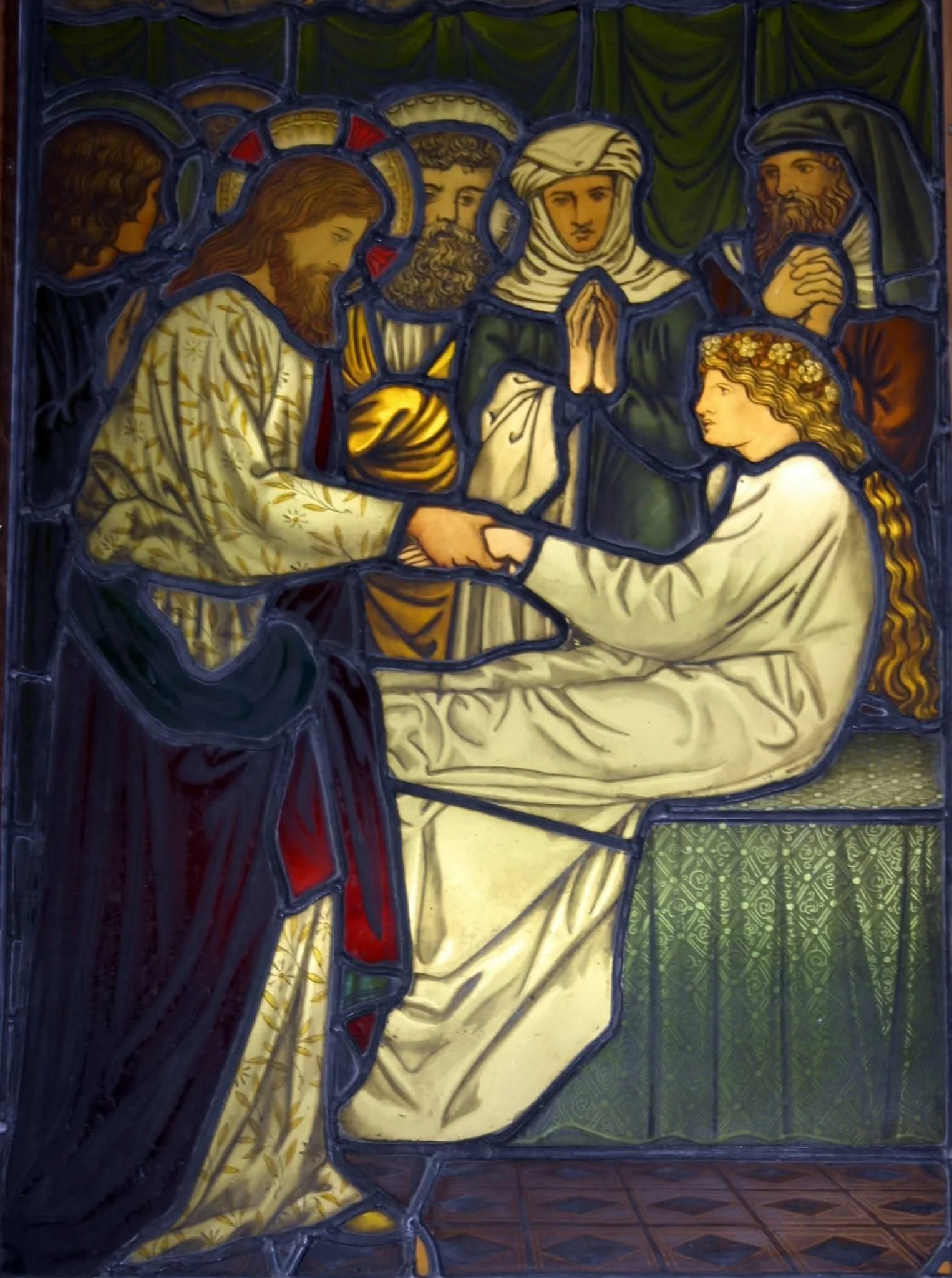 Colored stained glass window depicting a religious scene with Jesus Christ seated and holding hands with a woman, surrounded by four onlookers.