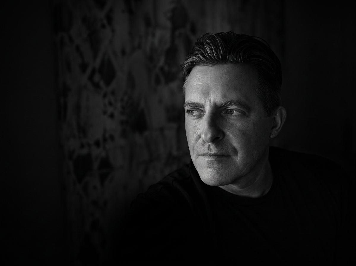 Black-and-white portrait of Scott Hancock, Founder of SayDoBrand™ in a black T-shirt, looking off camera
