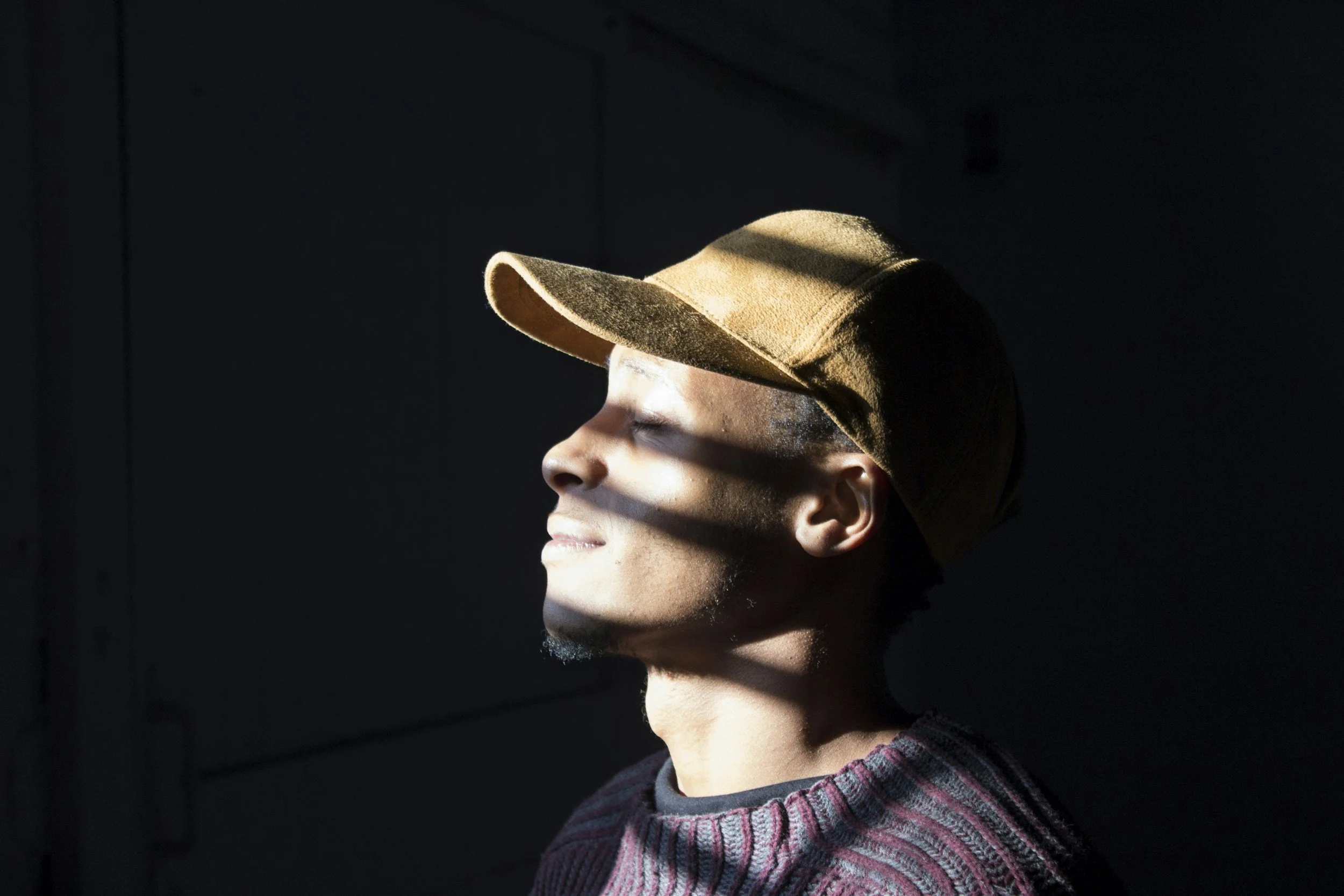 Man with eyes closed reflecting quietly during a moment of rest and gratitude at the end of his day.