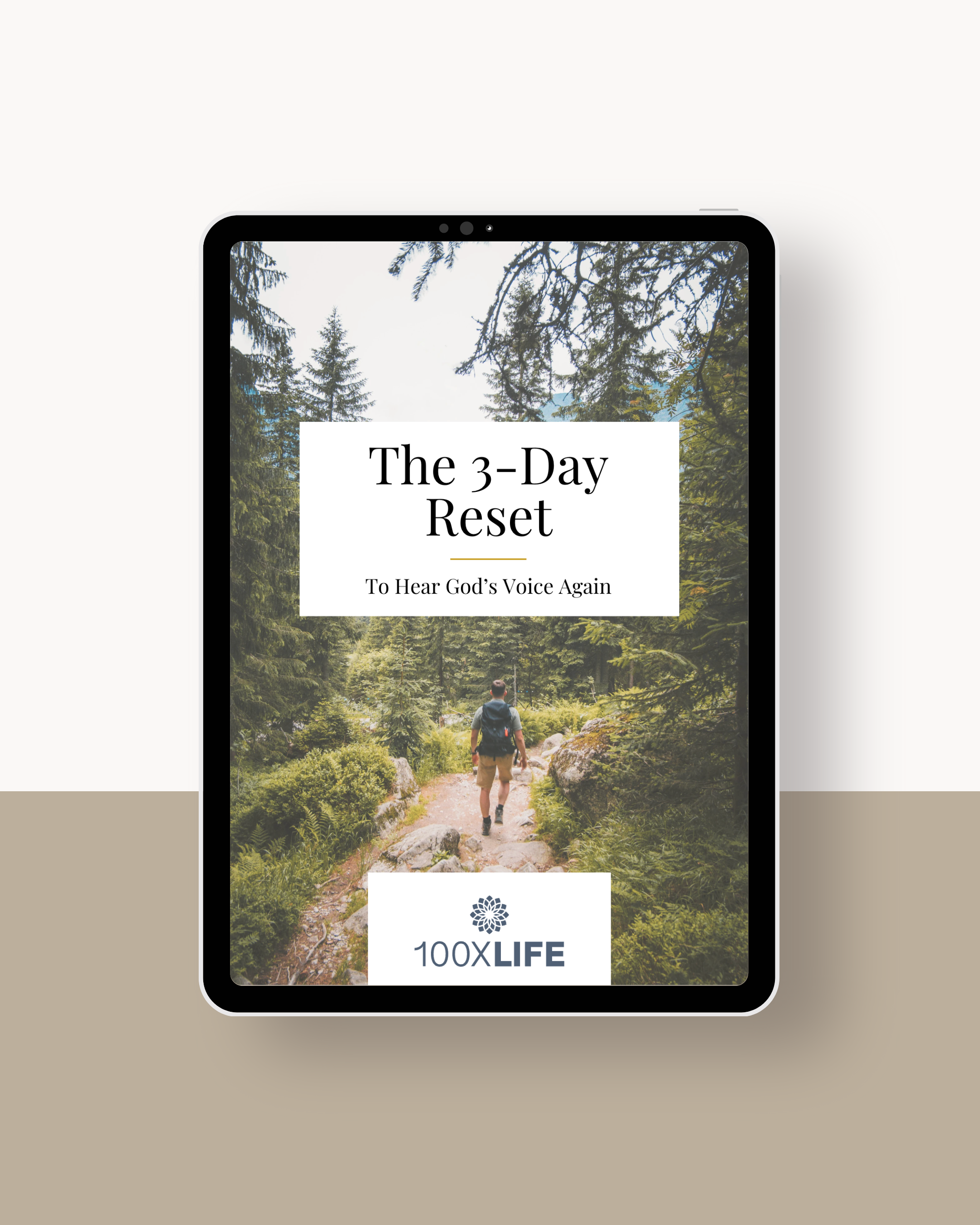 Digital tablet displaying a book cover titled 'The 3-Day Reset' with a subtitle 'To Hear God's Voice Again', featuring a man hiking through a forest trail surrounded by green trees.