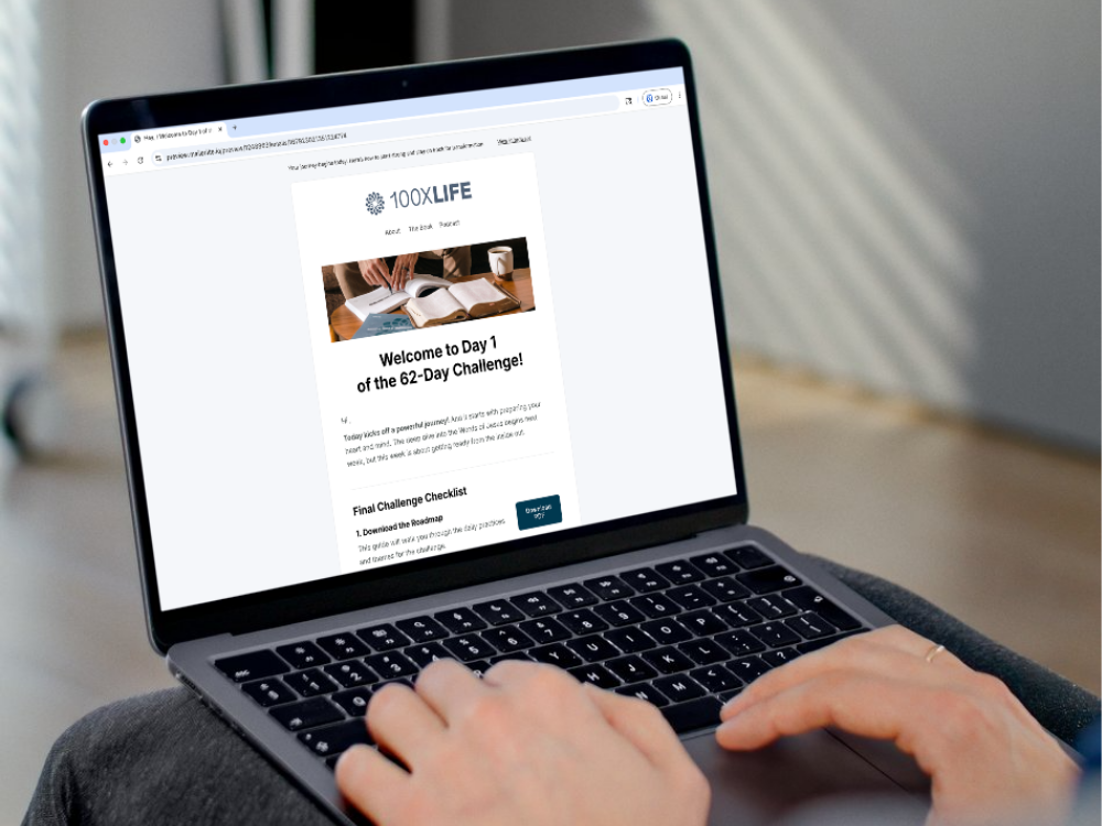 Person using a laptop to access the 100xLife welcome page for the 62-day challenge.