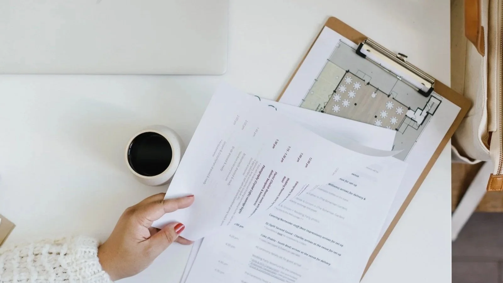 Wedding planner reviewing layout and timeline documents for a New York wedding