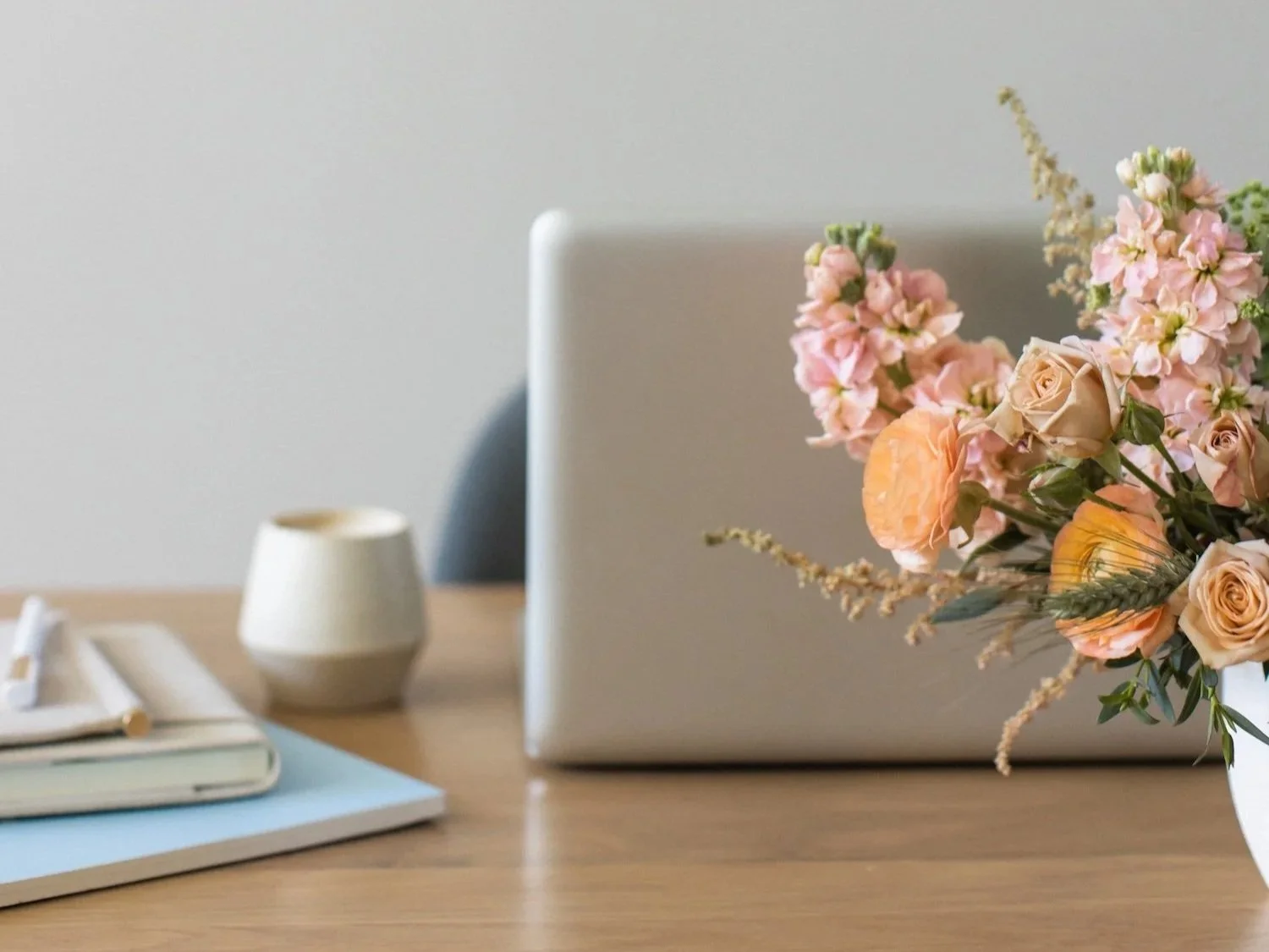 Planning a wedding guest list with laptop and notebook