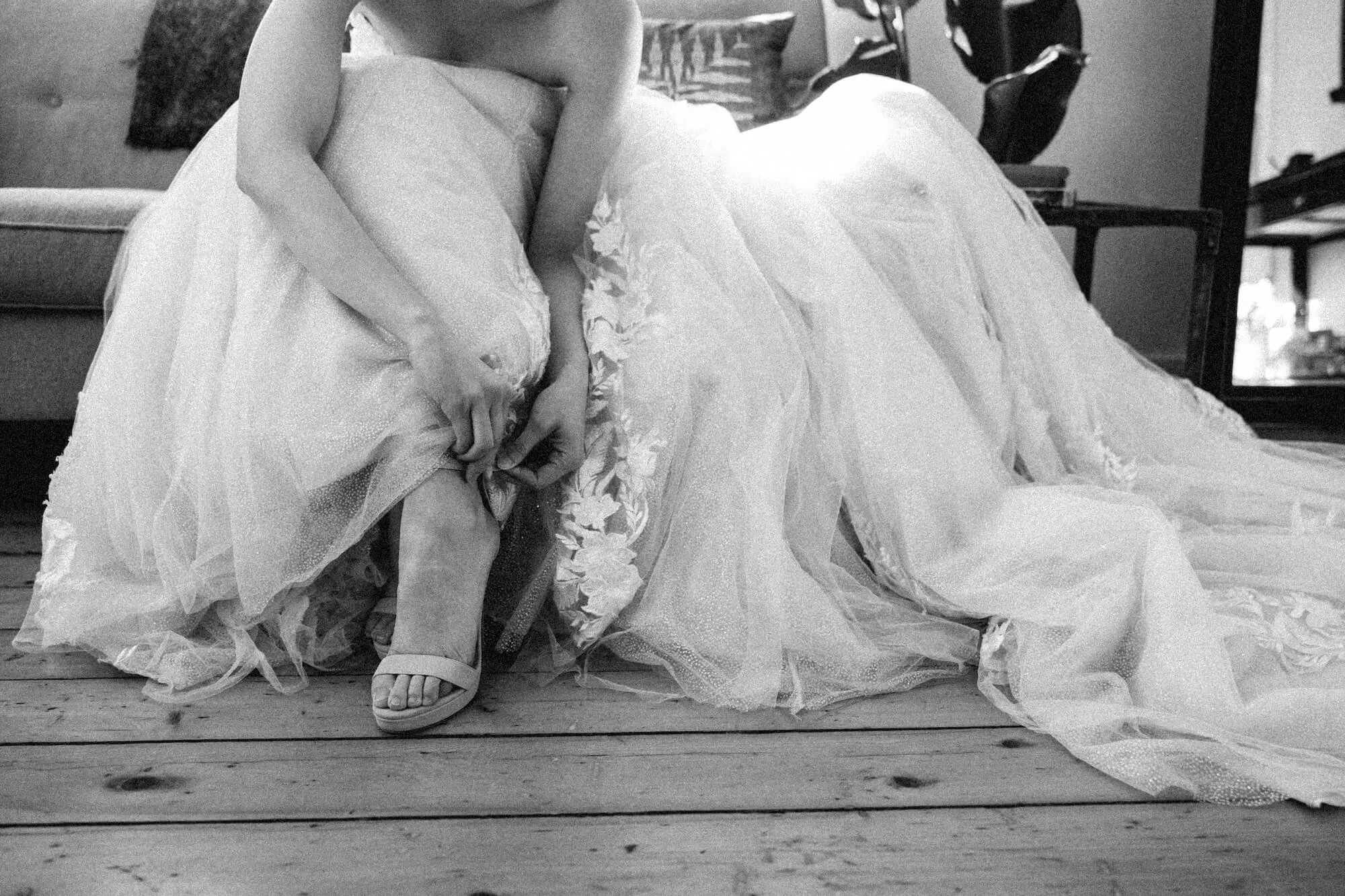 bride putting shoes on .jpeg