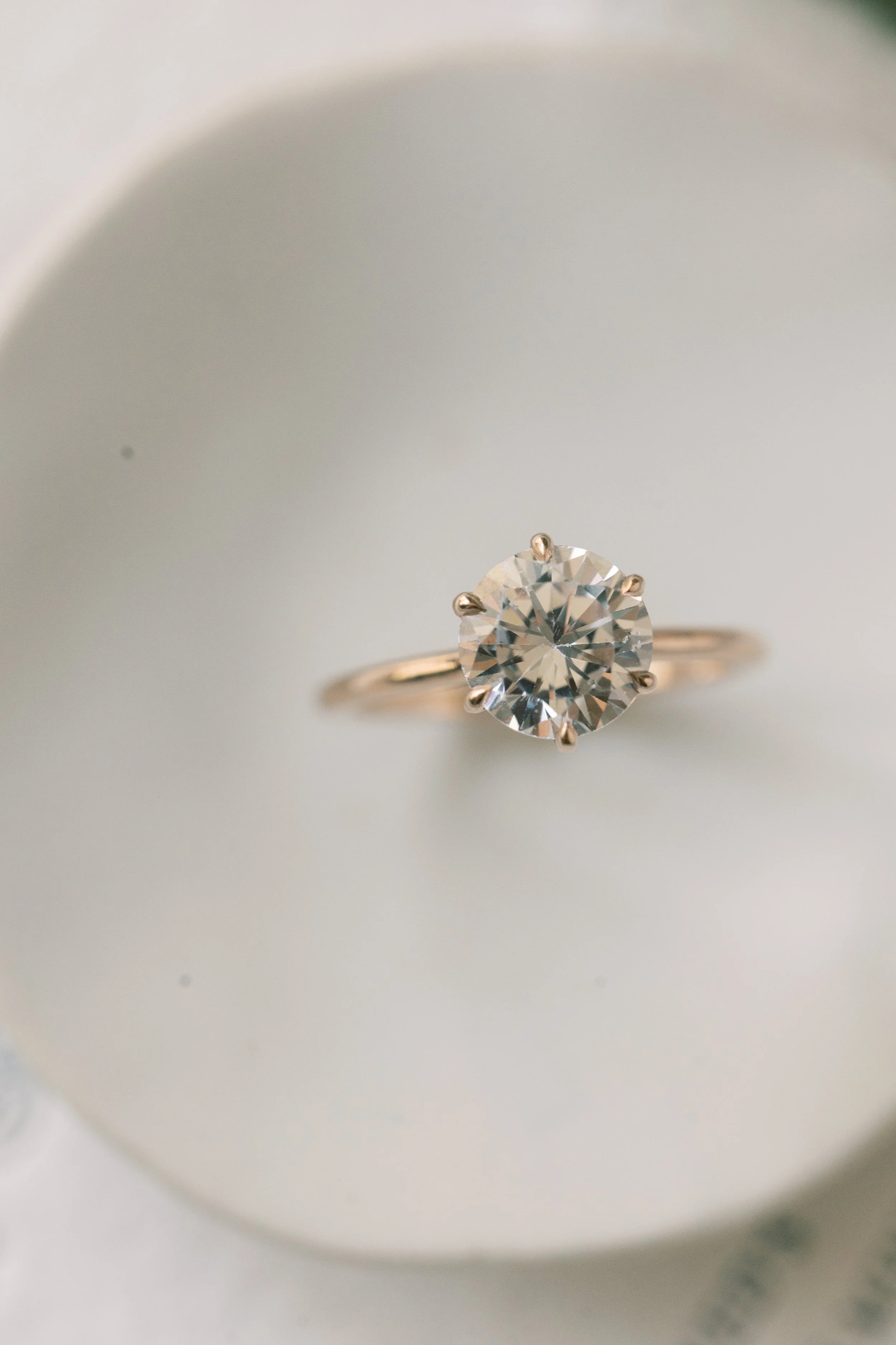 close_up_round_diamond_ring_on_ceramic_tray.jpg