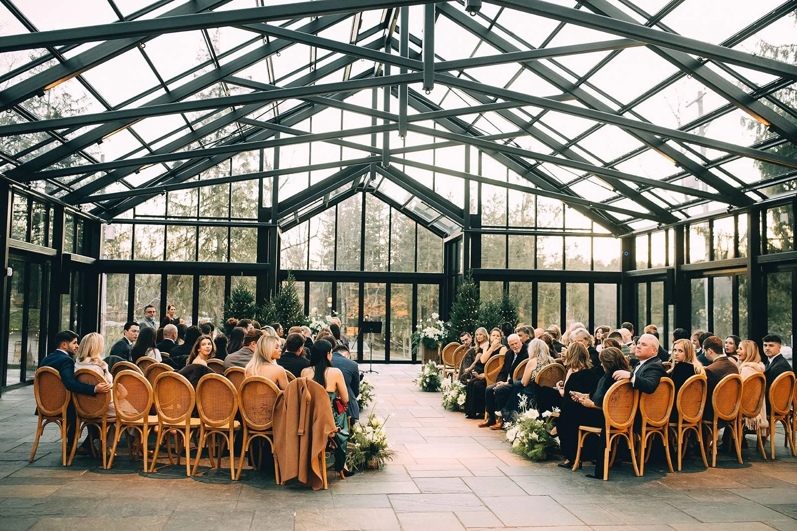 Indoor wedding ceremony at a modern New York wedding venue with guests seated before the ceremony begins.