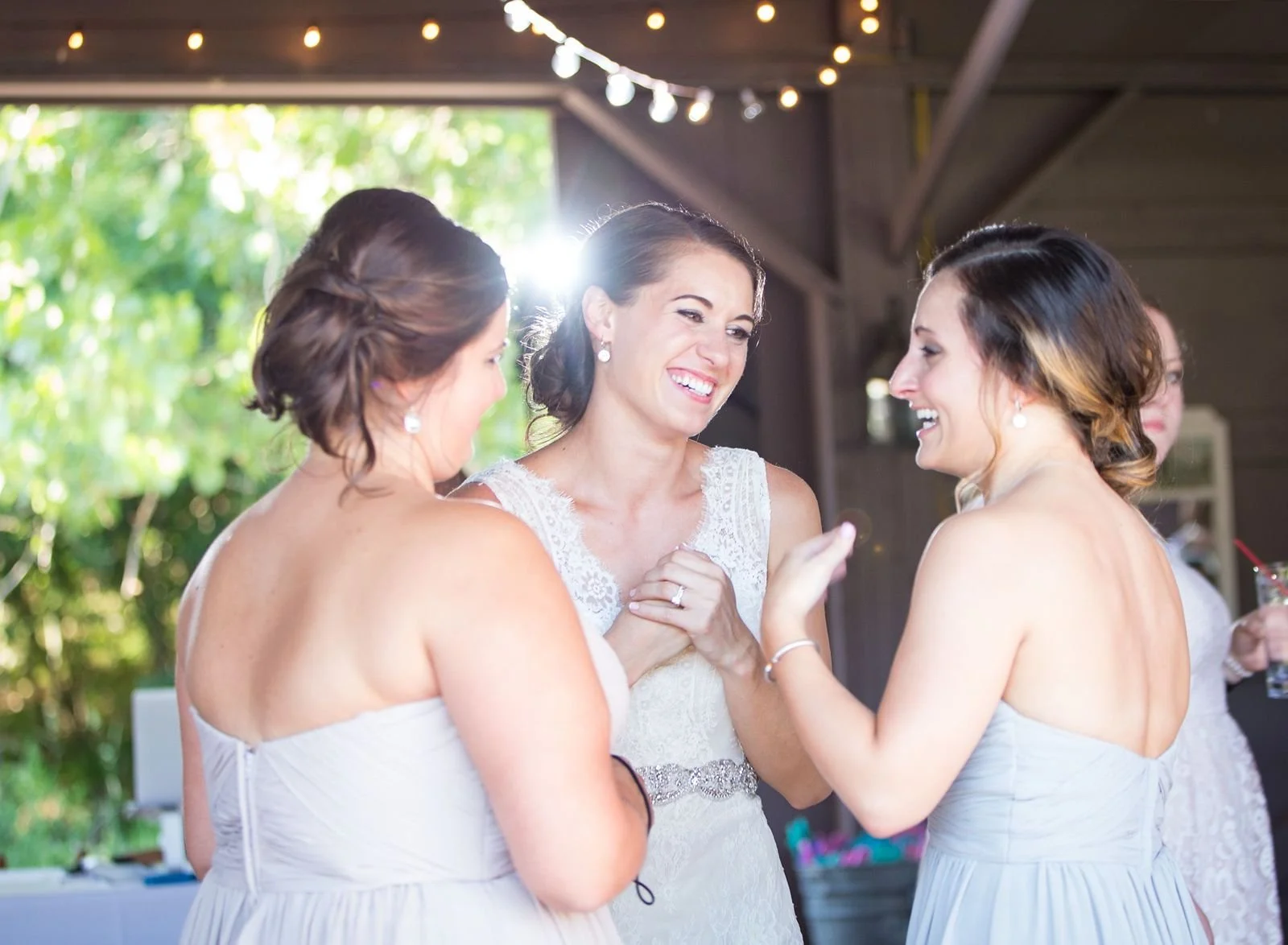 Bride sharing a joyful moment with close friends during an intimate wedding