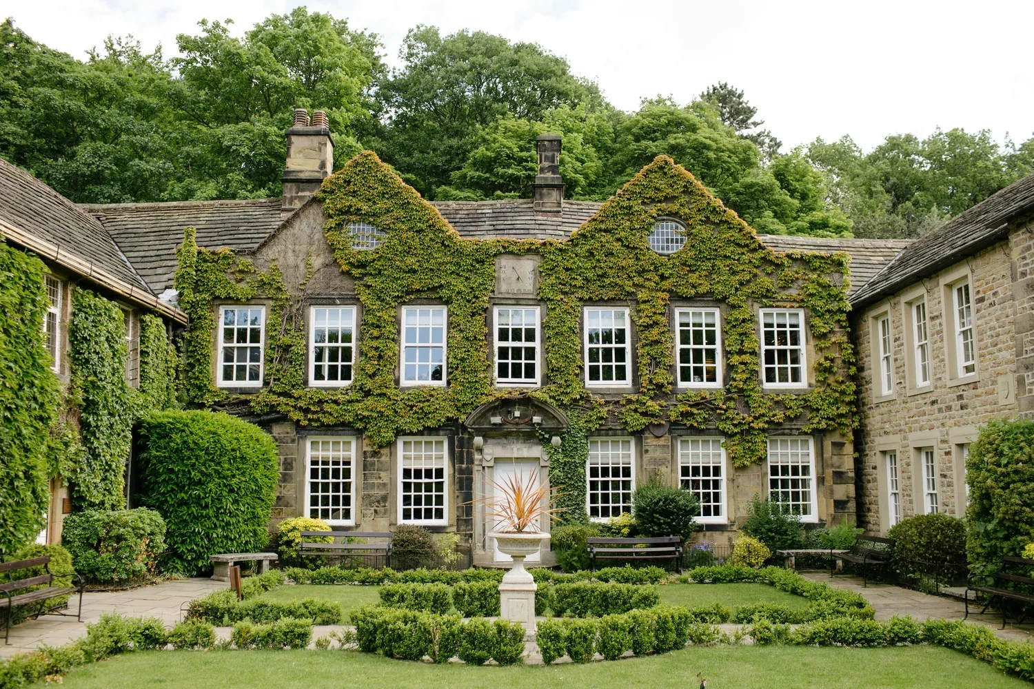 Ivy-covered historic estate with manicured gardens, perfect for an intimate wedding venue