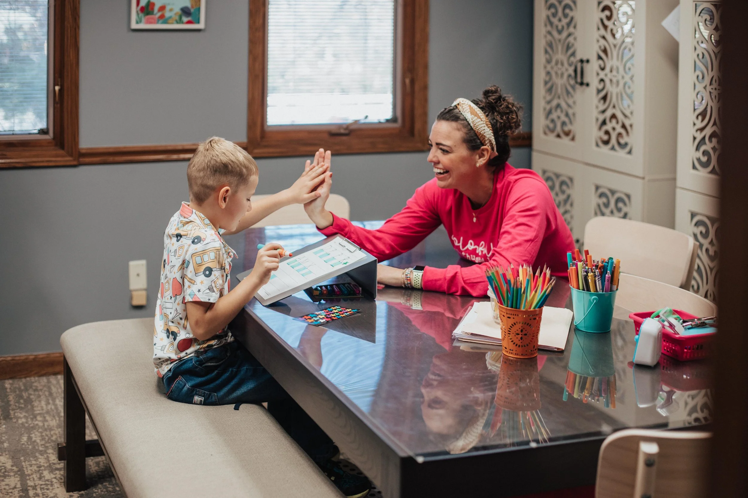 Occupational therapist in Westerville, OH high fiving a student.