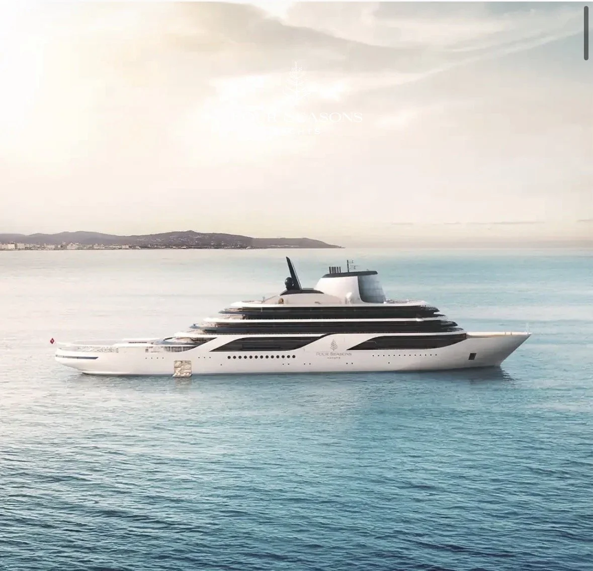 A luxury yacht on calm ocean waters with distant coastline and hills in the background.