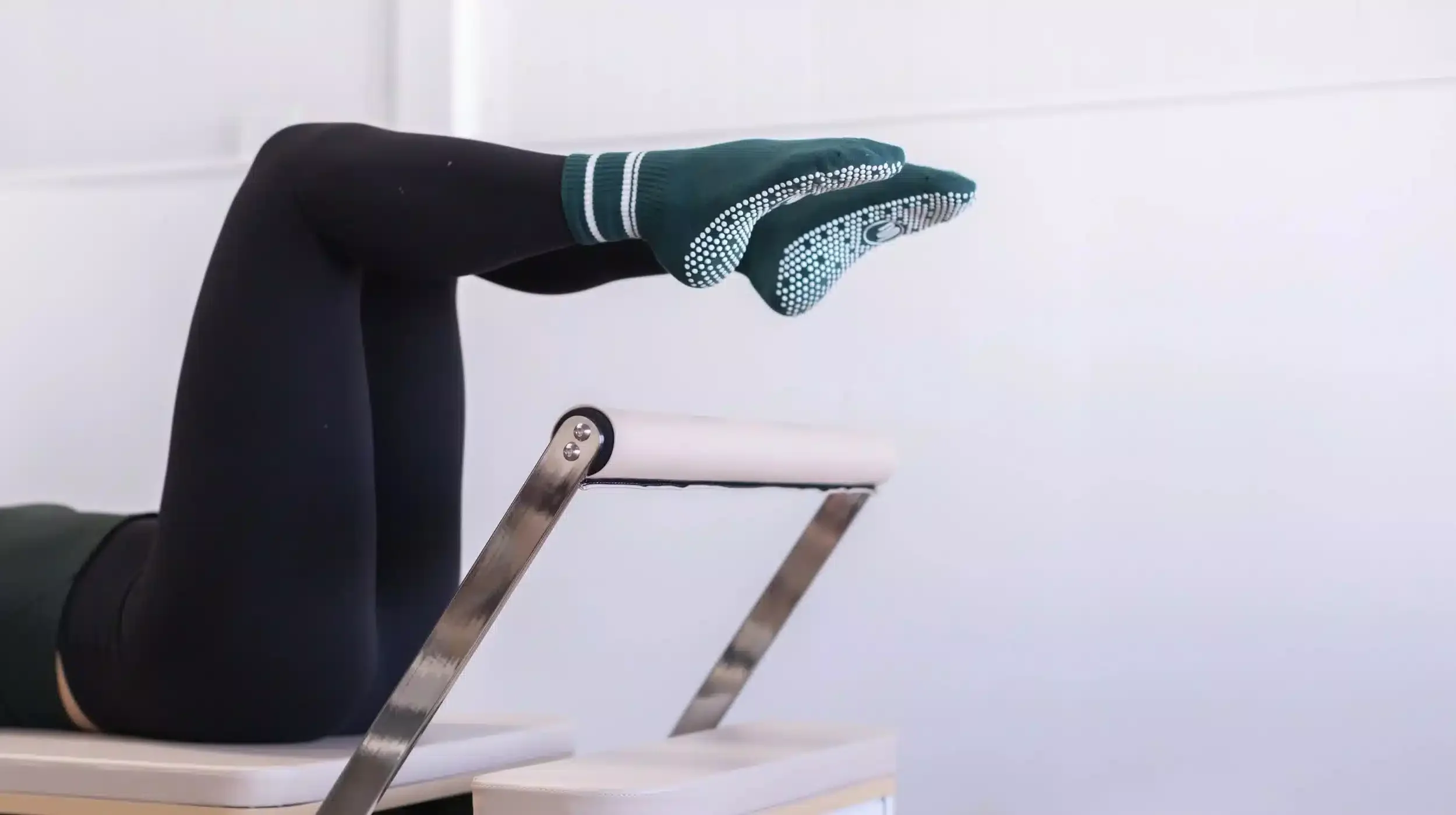 Legs in grip socks during a beginner reformer pilates class