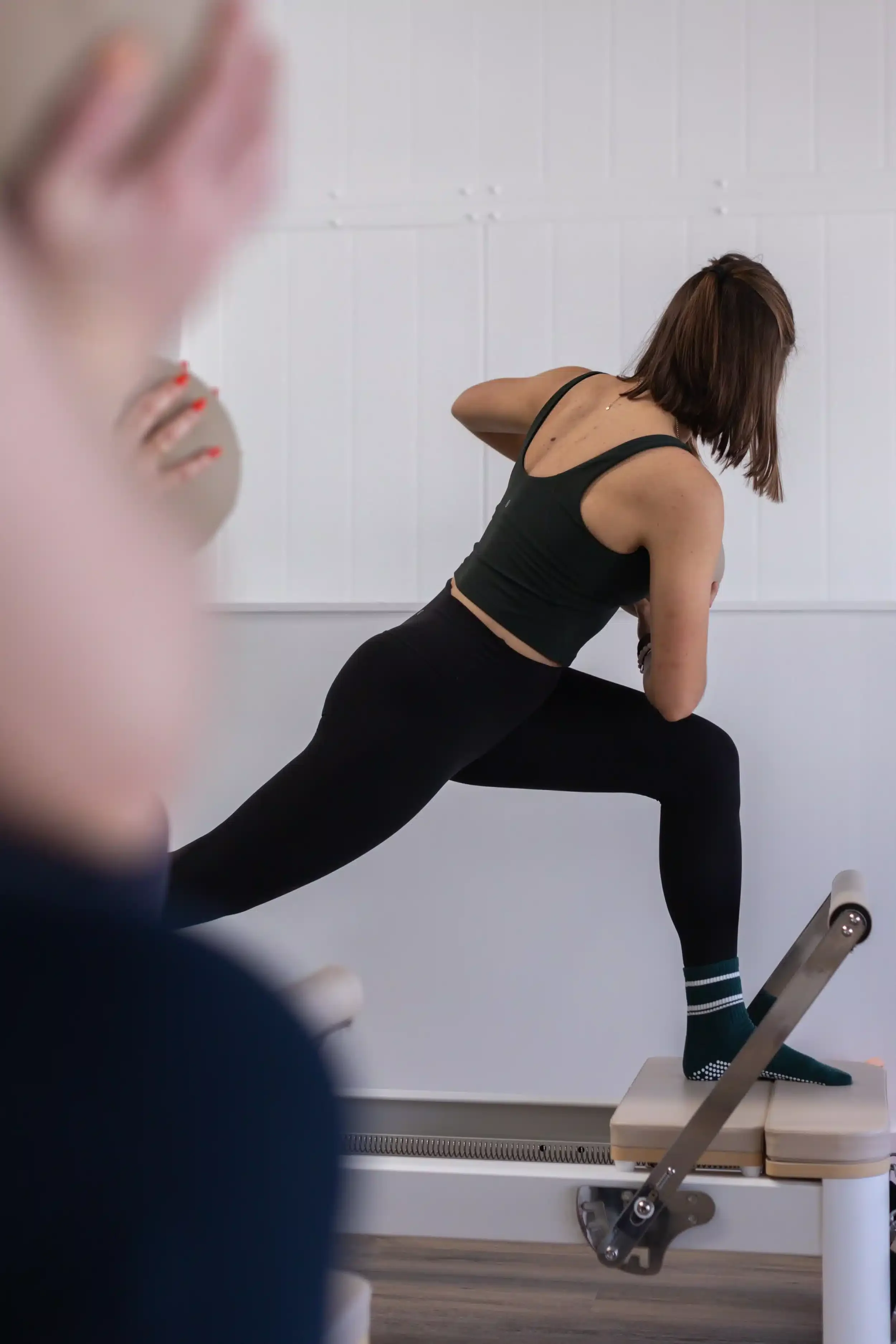 Woman doing a twisting mobility stretch with a ball