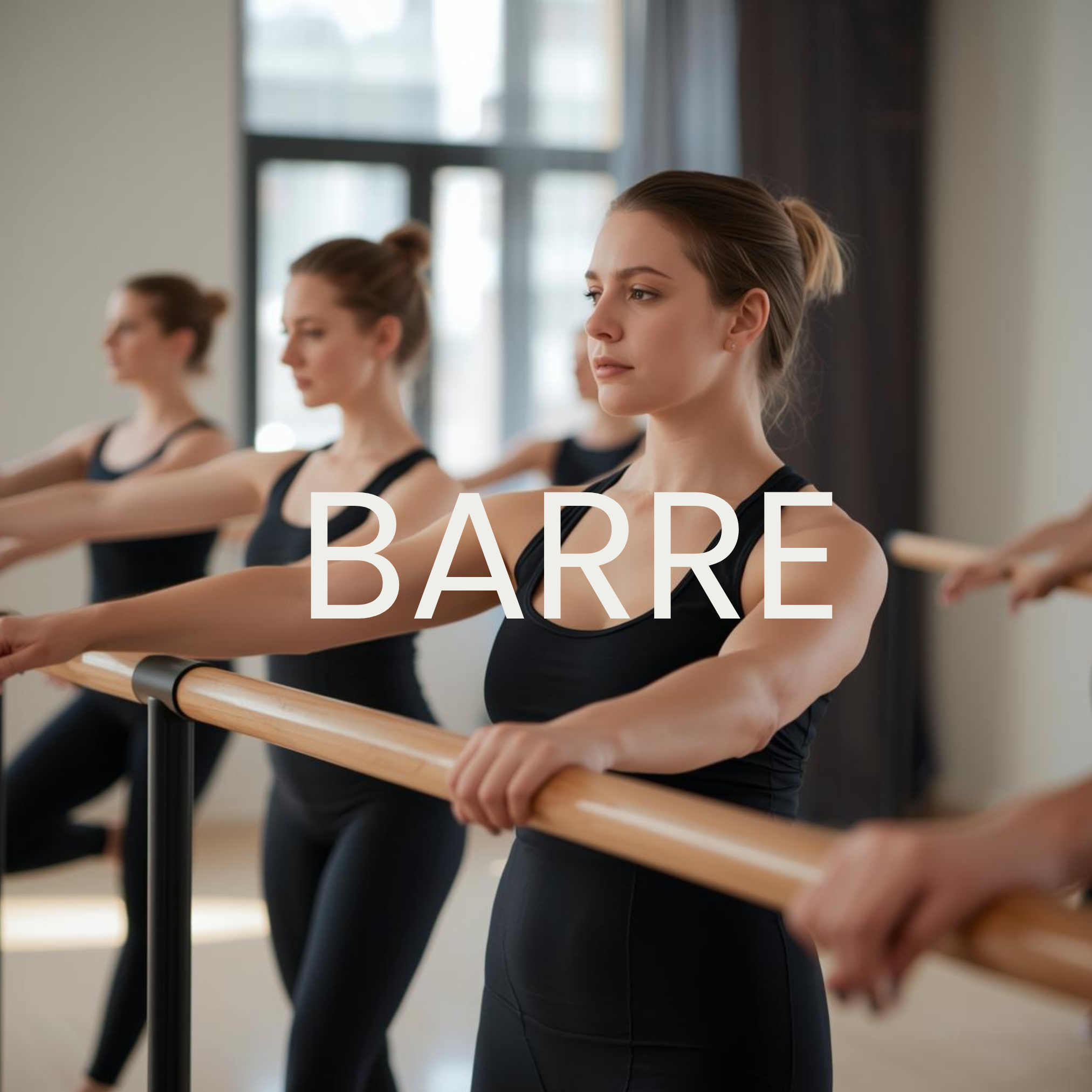 Group of women participating in a barre exercise class, standing at a ballet barre with arms extended forward, in a bright studio with large windows.