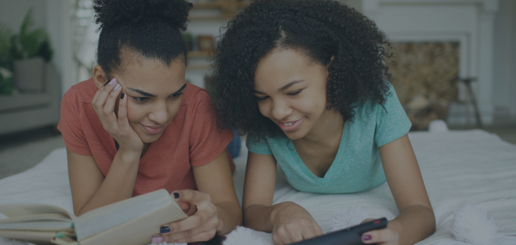 two kids/teens reading together