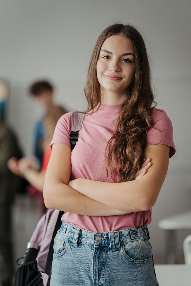Teen girl with backpack on smiling