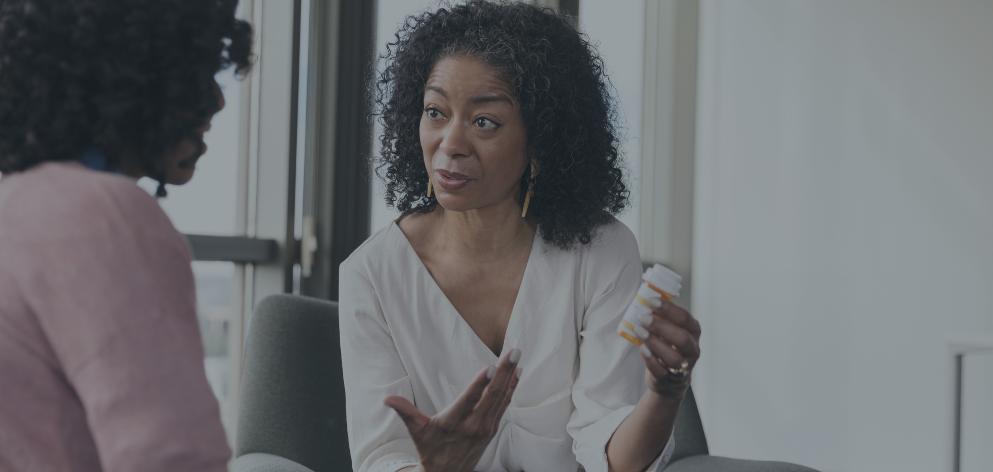 Women holding up medication bottle