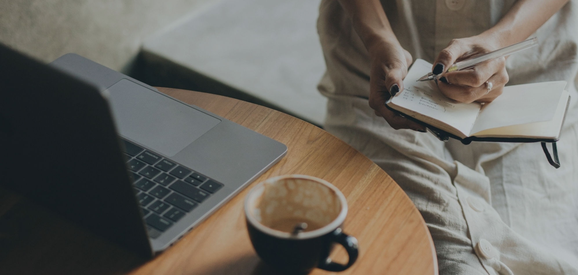 Women conducting psychological evaluation sitting at desk with computer and coffee