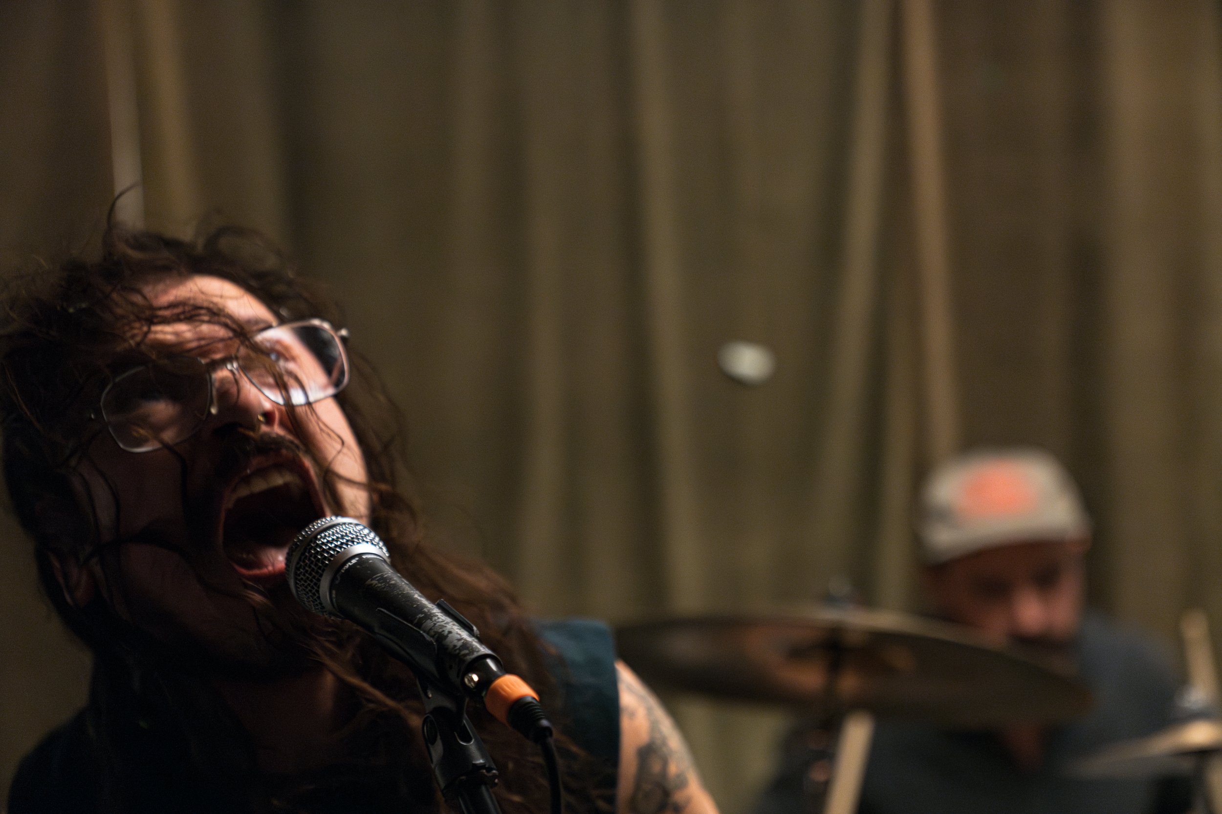 Denno Asfeteros, frontman for the alternative/indie rock and punk band Caustic Cadavres, practices with bandmates in Austin, Texas, on May 27, 2023.