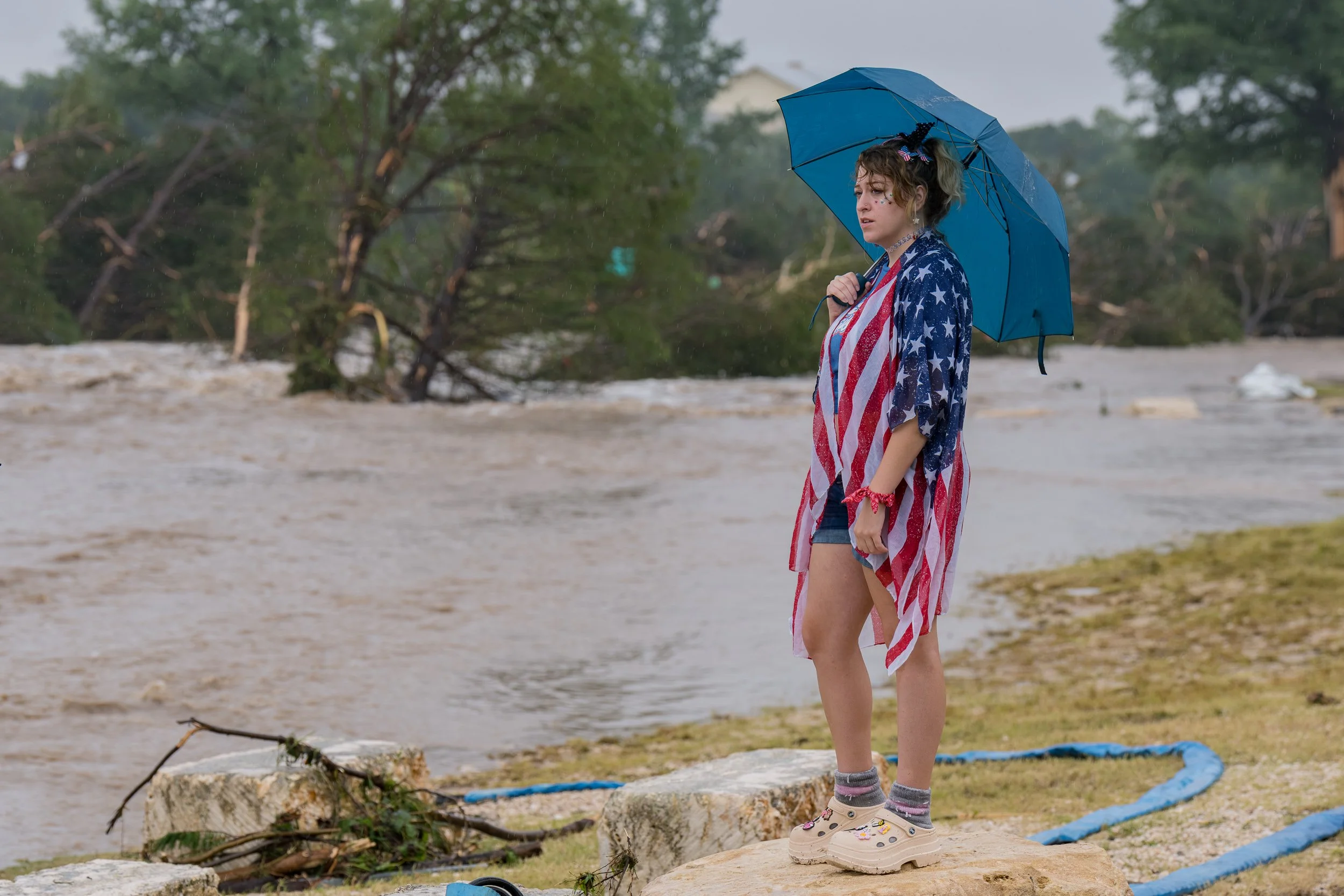 Kerrville resident Leighton Sterling watches floodwaters along the Guadalupe River in Kerrville, Texas, on July 4, 2025, after heavy rainfall triggered deadly flash flooding across Central Texas.