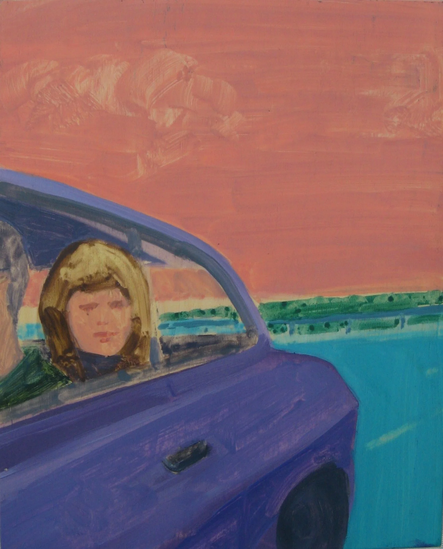 A young girl looks out from a vehicle.