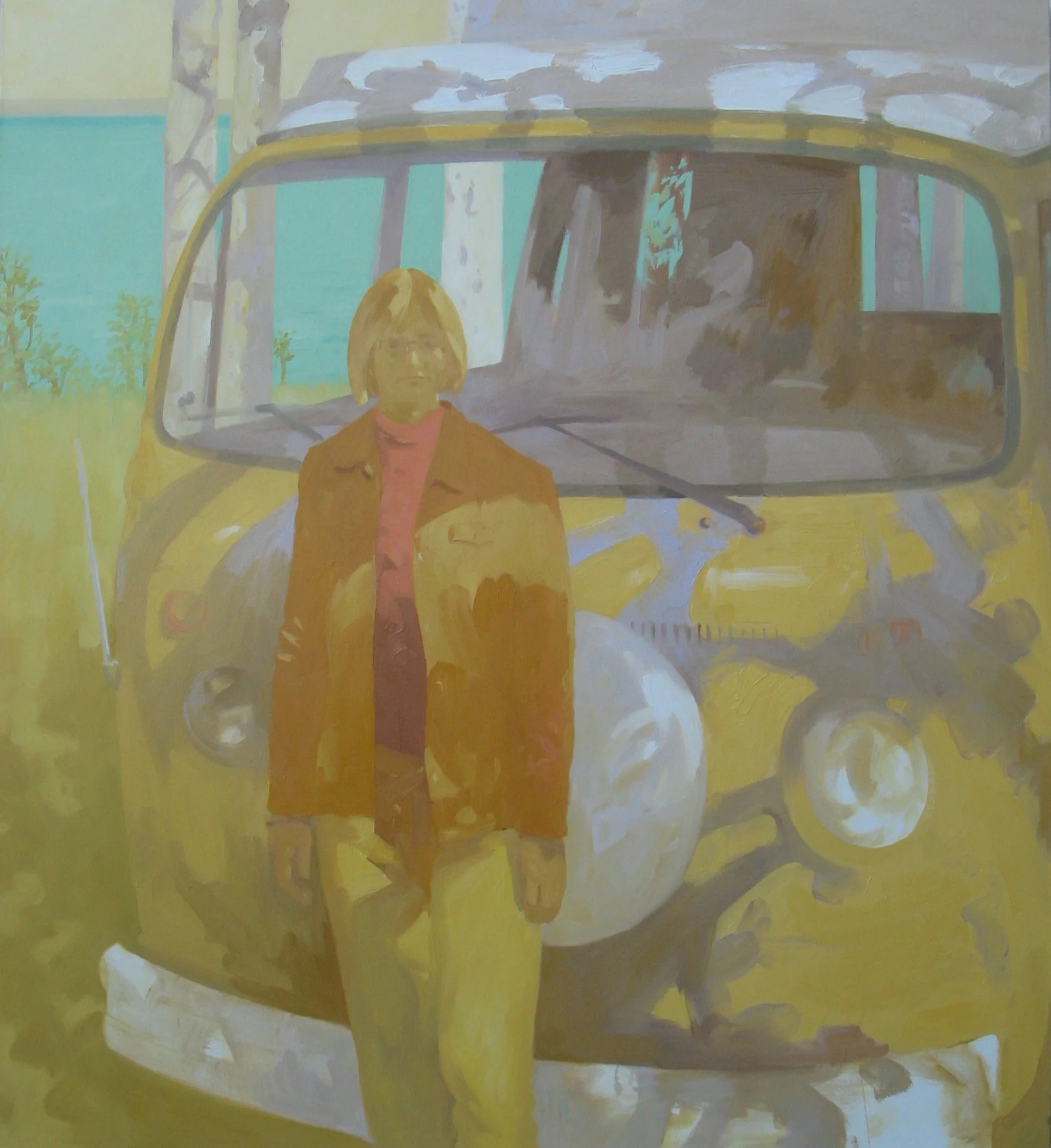 A woman stands in front of a VW westfalia.